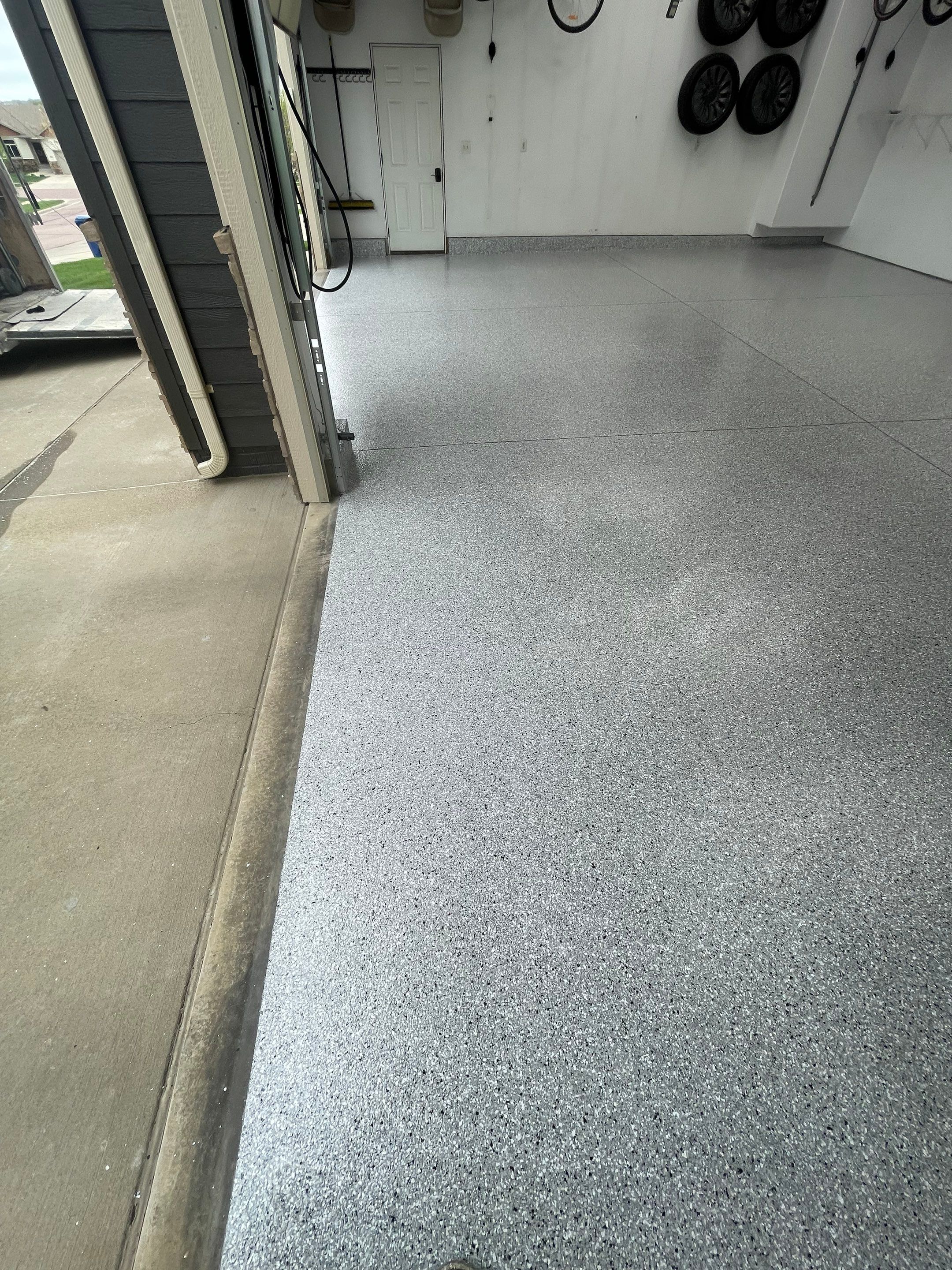 Feather Gray Epoxy Floor Coating Installation in Sioux Falls by Select Painting, Coatings & Garage Cabinets