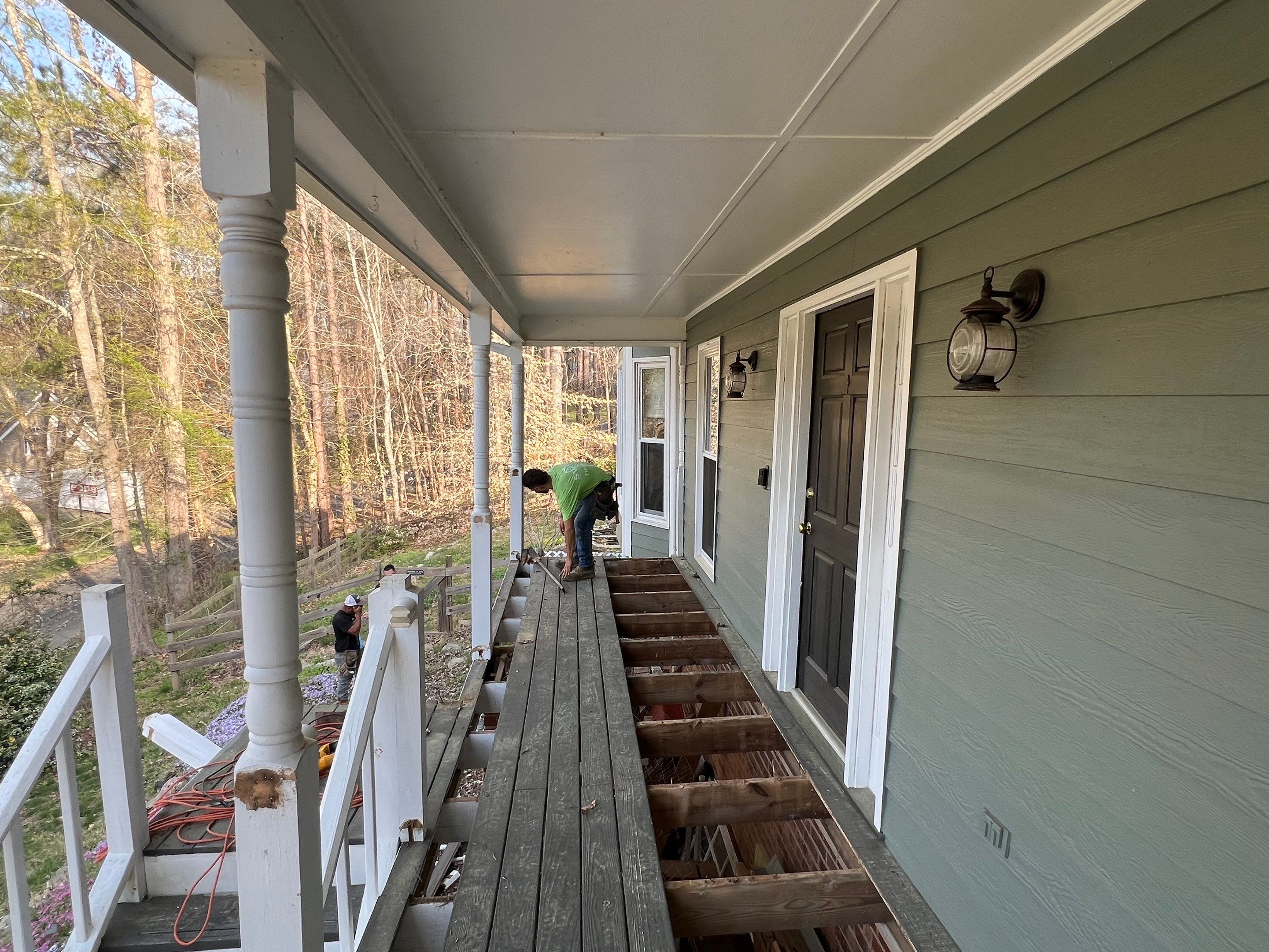 Composite Deck and Porch Renovation With Black Metal Railings by Swift Home Renovations 