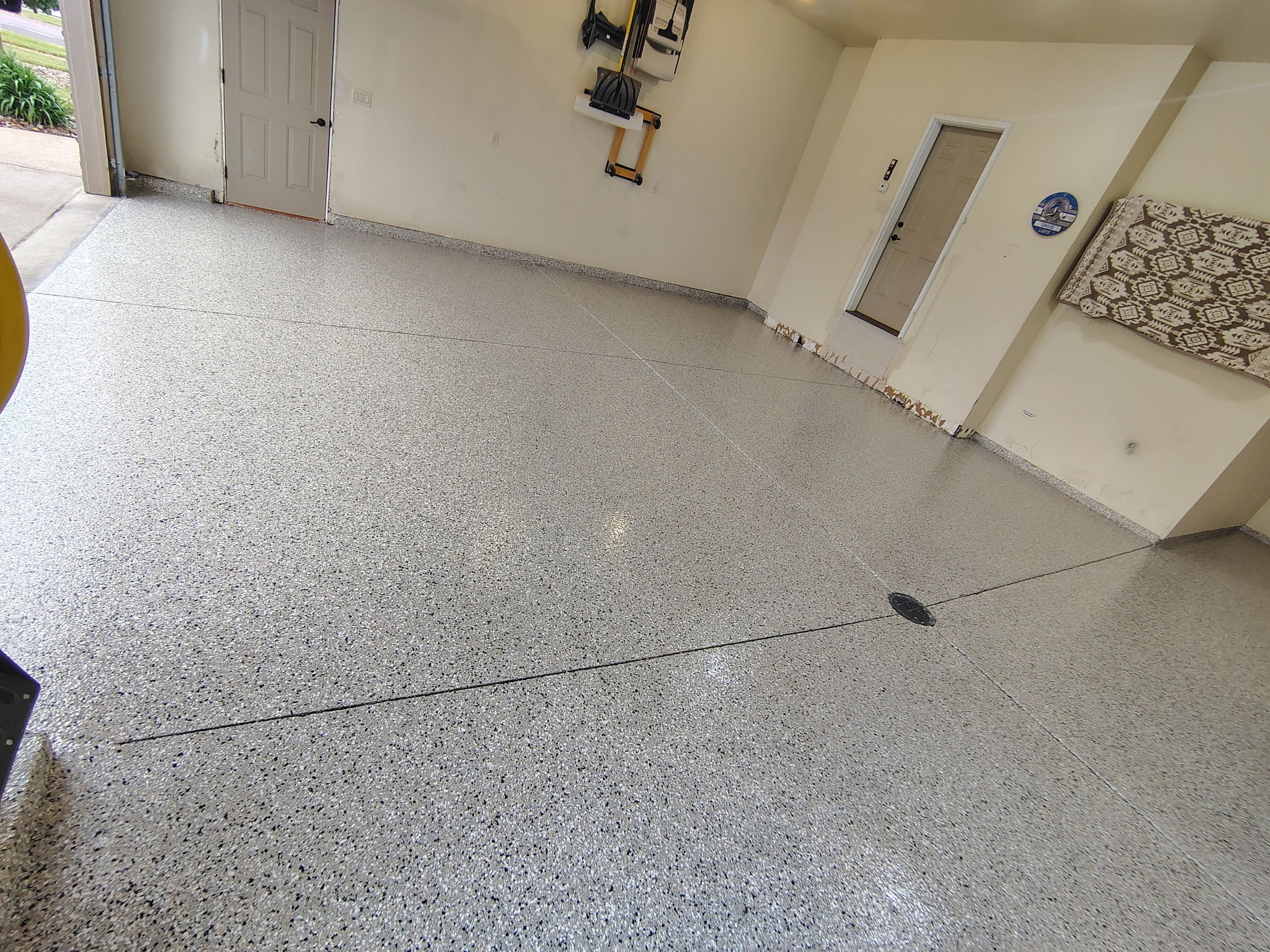 Sioux Falls Garage Floor Repair and Speckled Epoxy Coating Installation by Select Painting, Coatings & Garage Cabinets