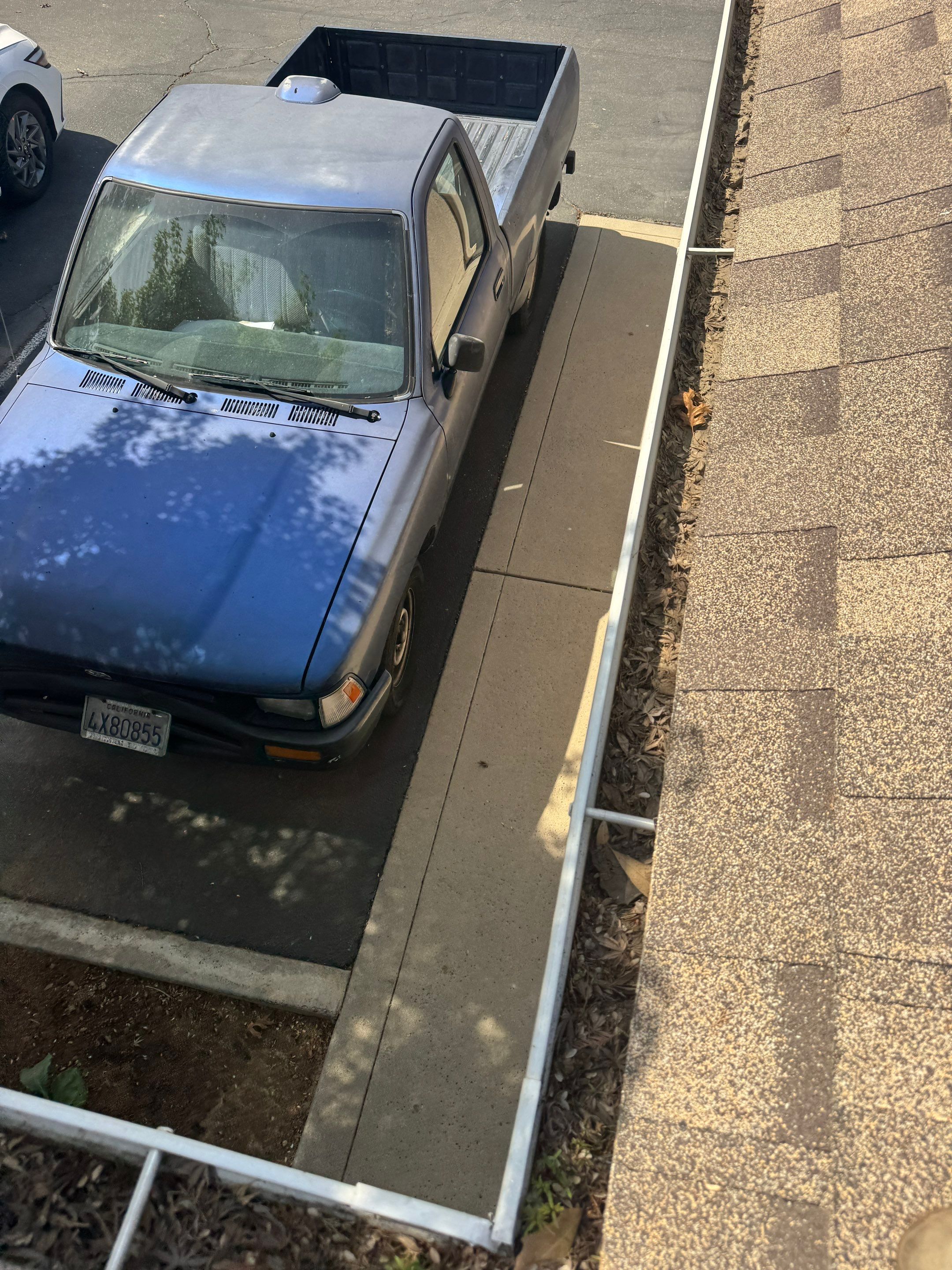 Commercial gutter cleaning Fresno, CA before photo with filled gutters