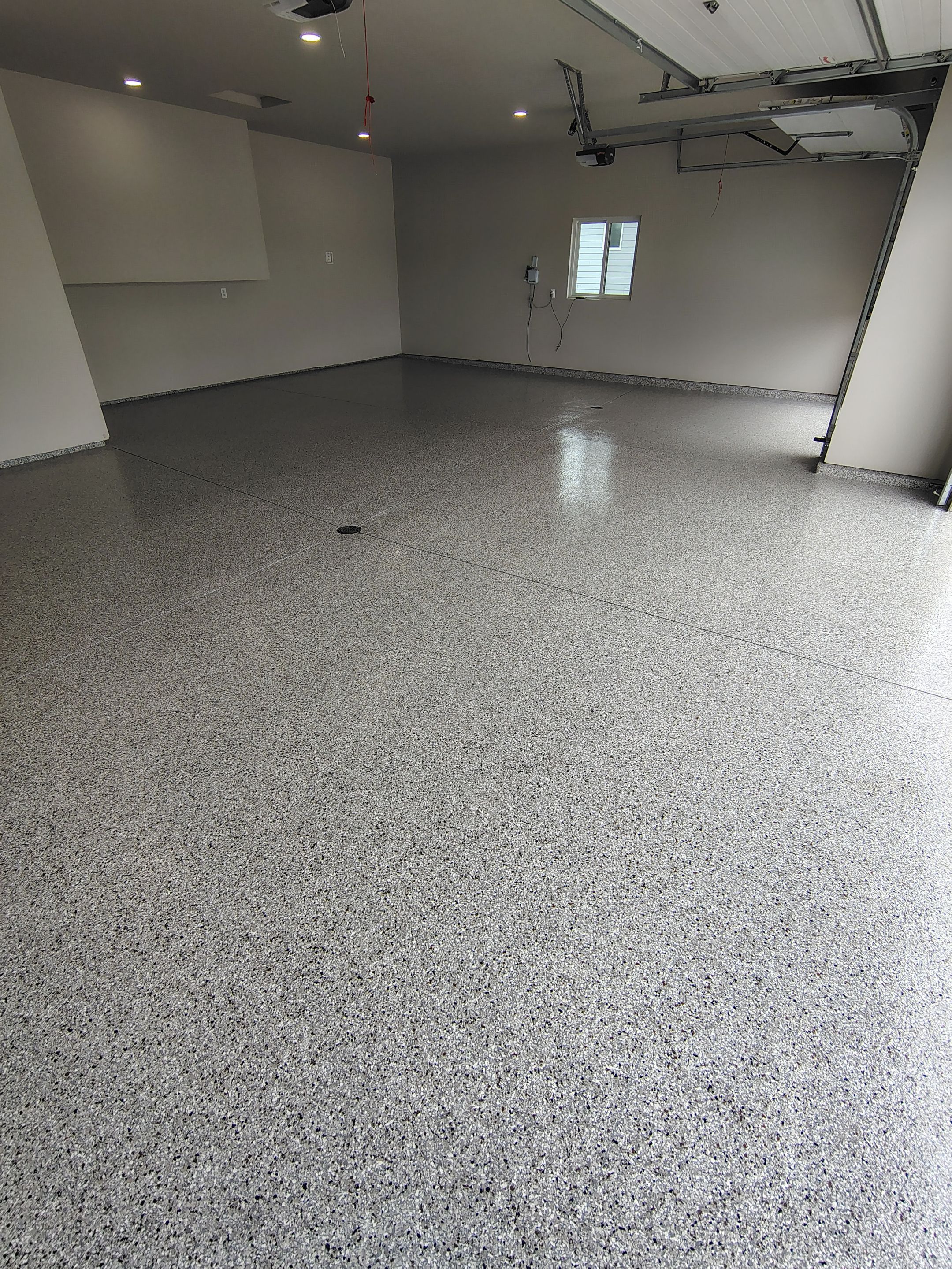 Grey Speckled Epoxy Garage Floor Coating in Sioux Falls by Select Painting, Coatings & Garage Cabinets