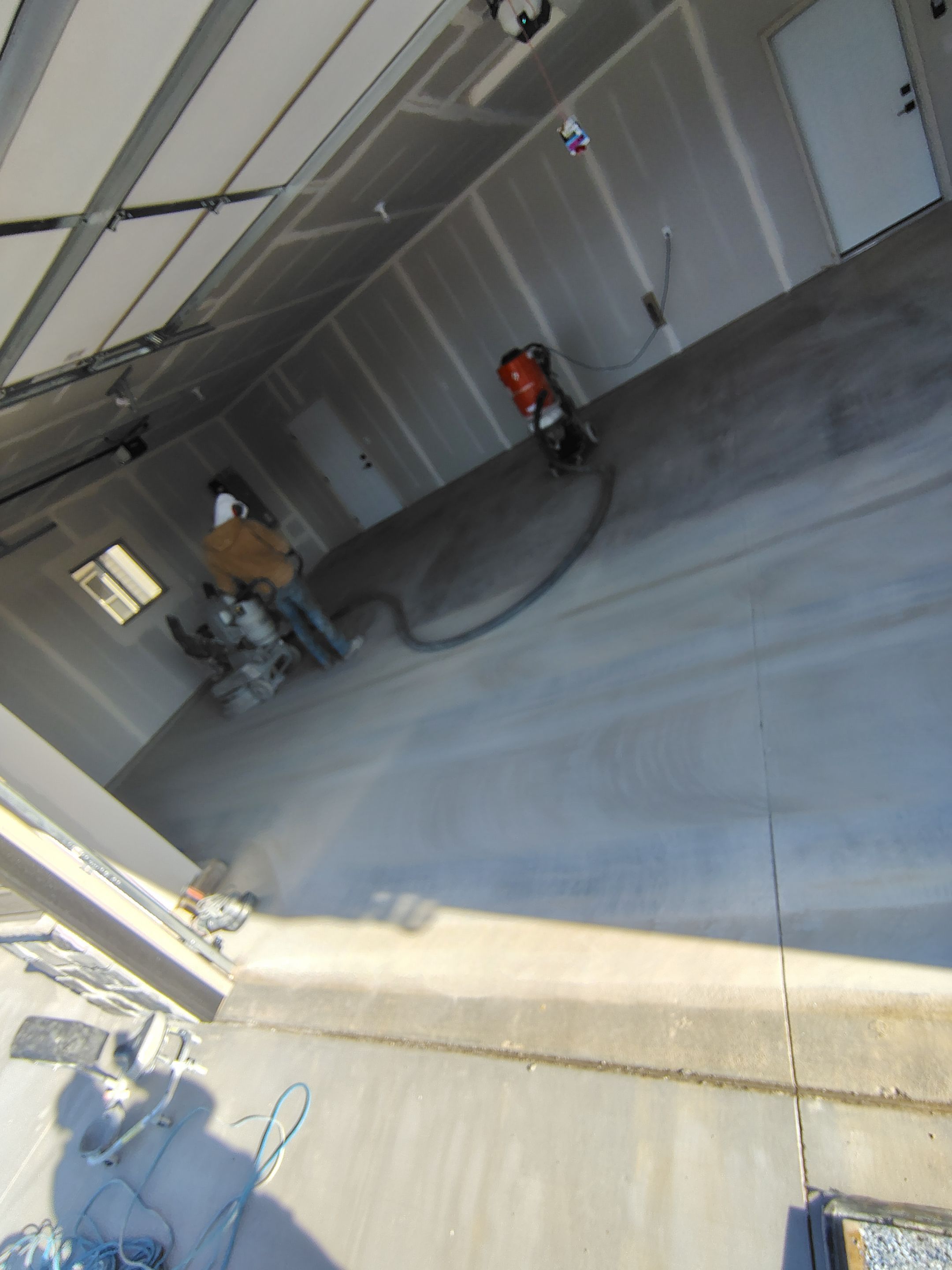 Speckled Epoxy Garage Floor Coating Installation in Sioux Falls by Select Painting, Coatings & Garage Cabinets