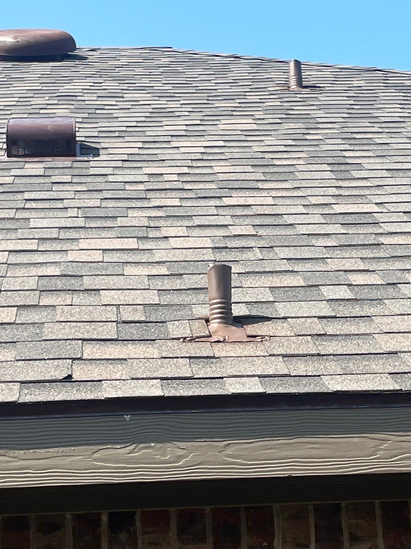 Medium brown brick with IKO Driftshake by Tejas Roofworks + Restoration