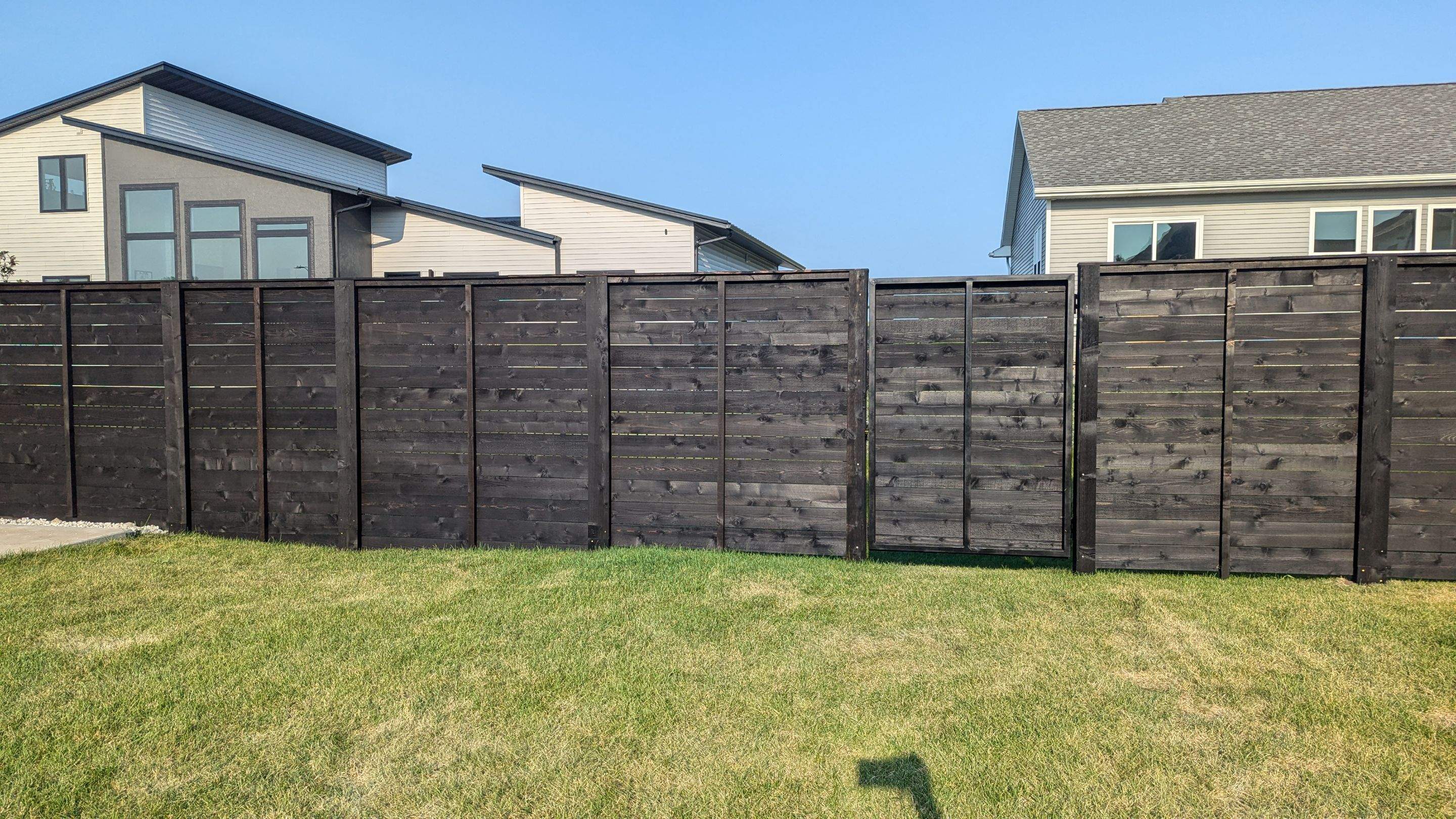 Modern Black Stained Horizontal Privacy Fence Installation in Cedar by Perfect Picket Fence and Stain
