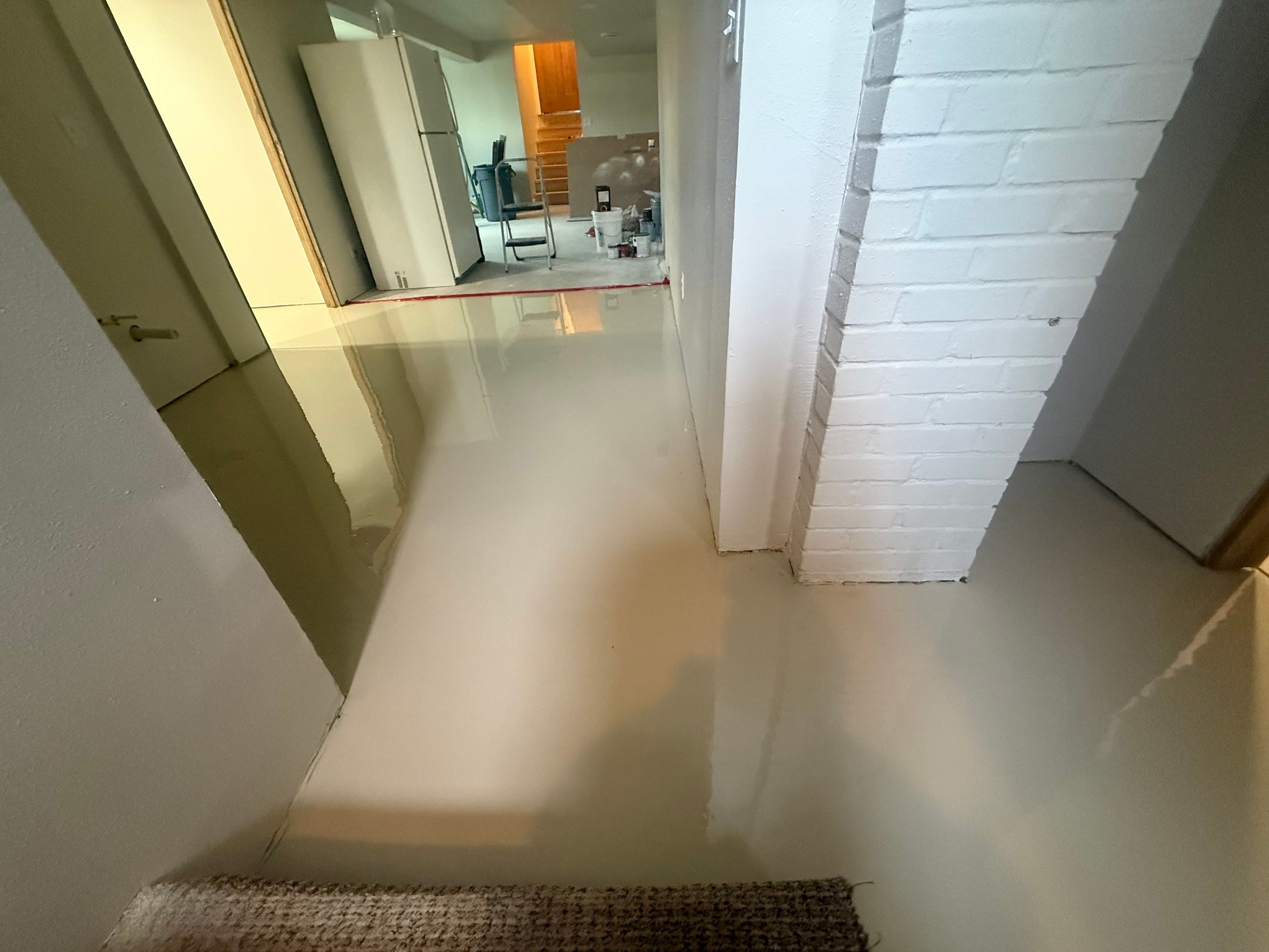 High-Gloss Epoxy Floor Coating and Basement Renovation in Rock Rapids by Select Painting, Coatings & Garage Cabinets