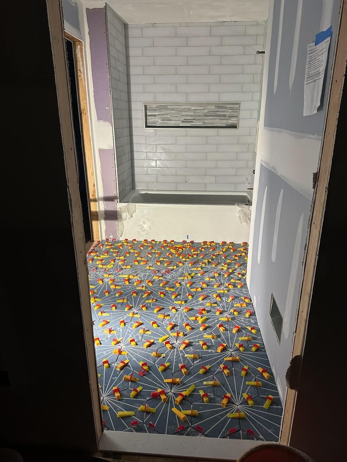 Jack & Jill Bathroom Floor + Dog Washing Nook with Niche using Porceline Subway Tile by Footprints Floors Morristown