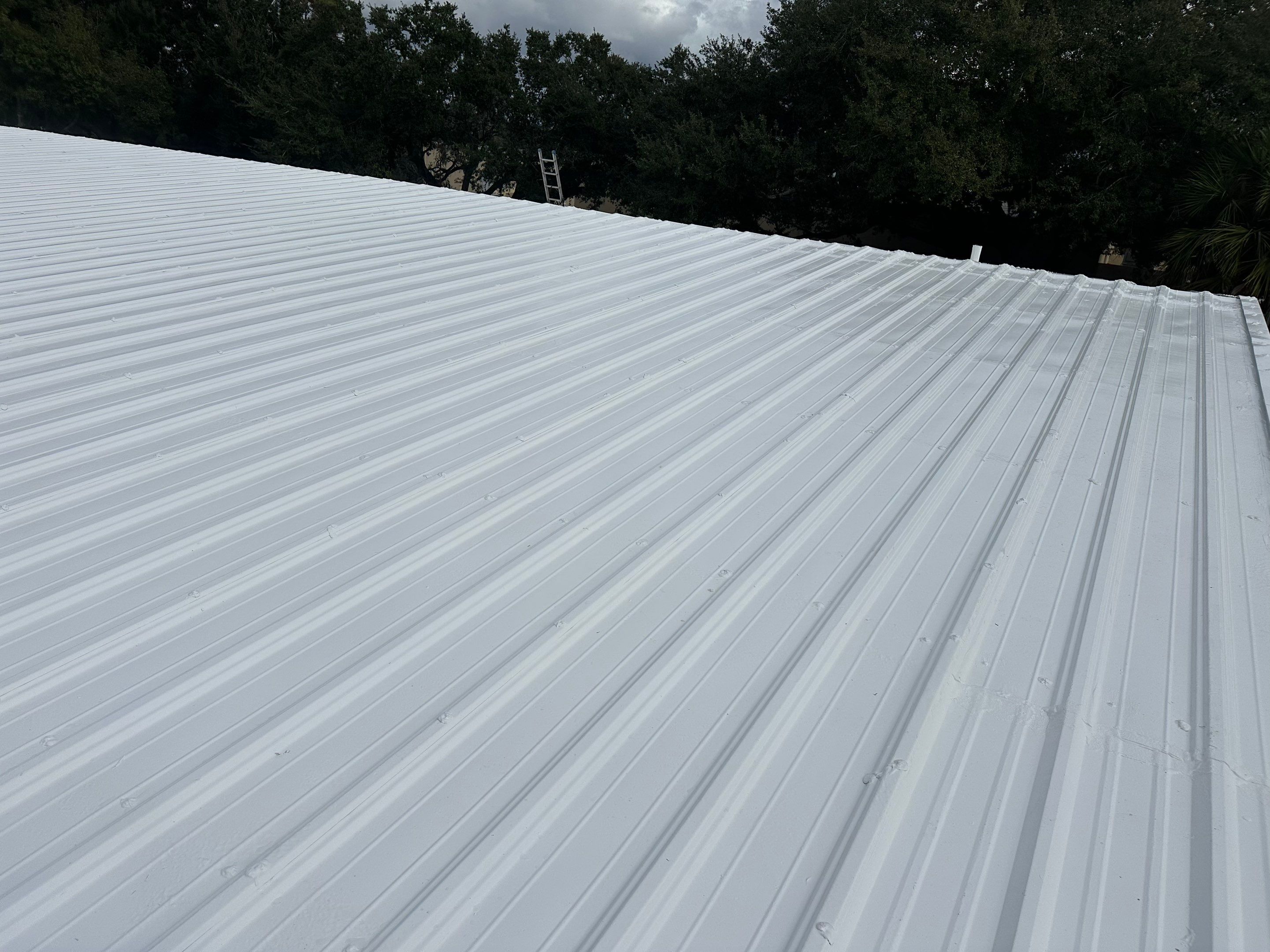 Industrial Metal Roof Restoration With Silicone Coating in Winter Park by CES Roofing