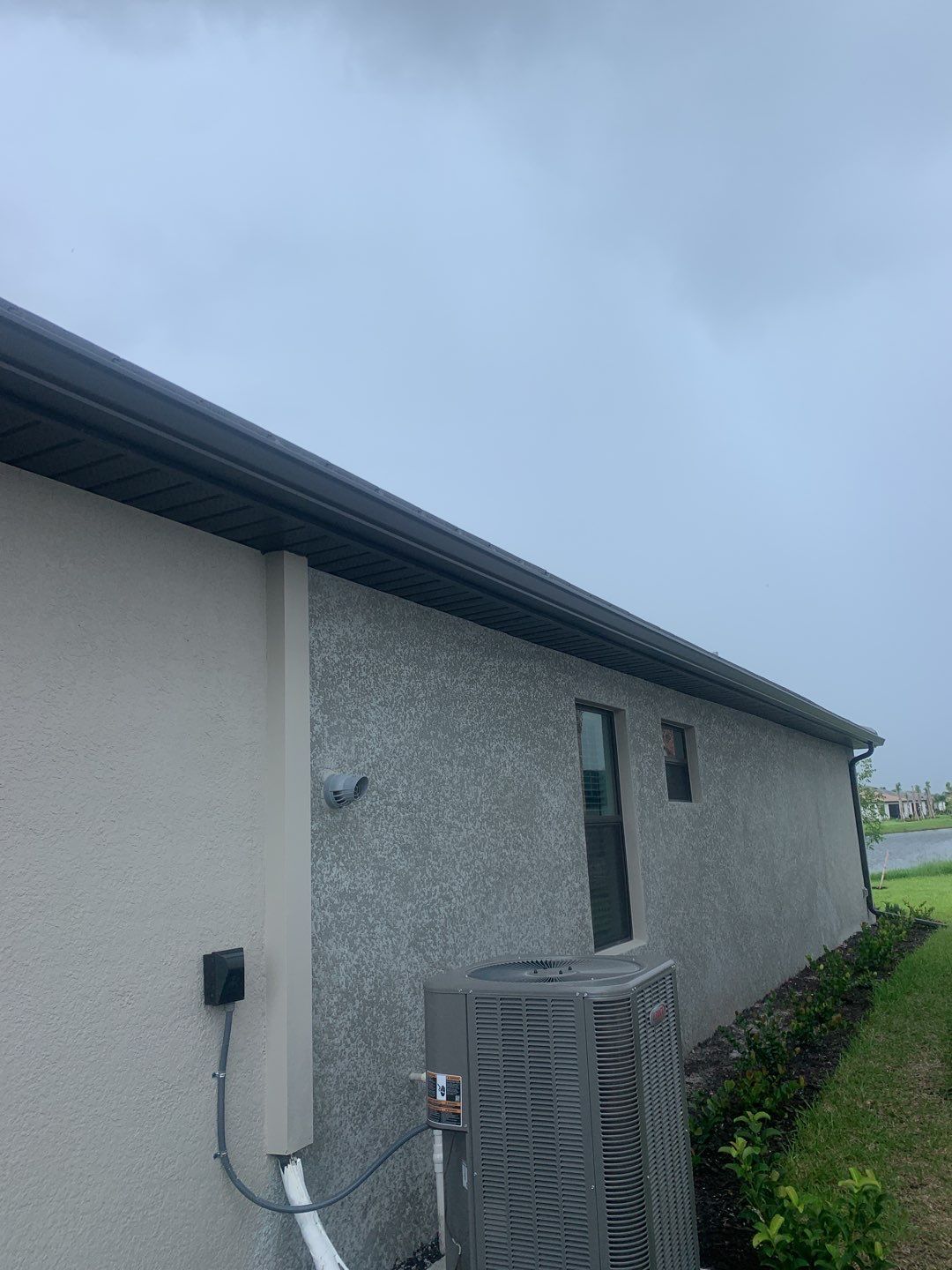 Seamless brown gutter and downspouts installation in Estero, FL  by Gutter Professors