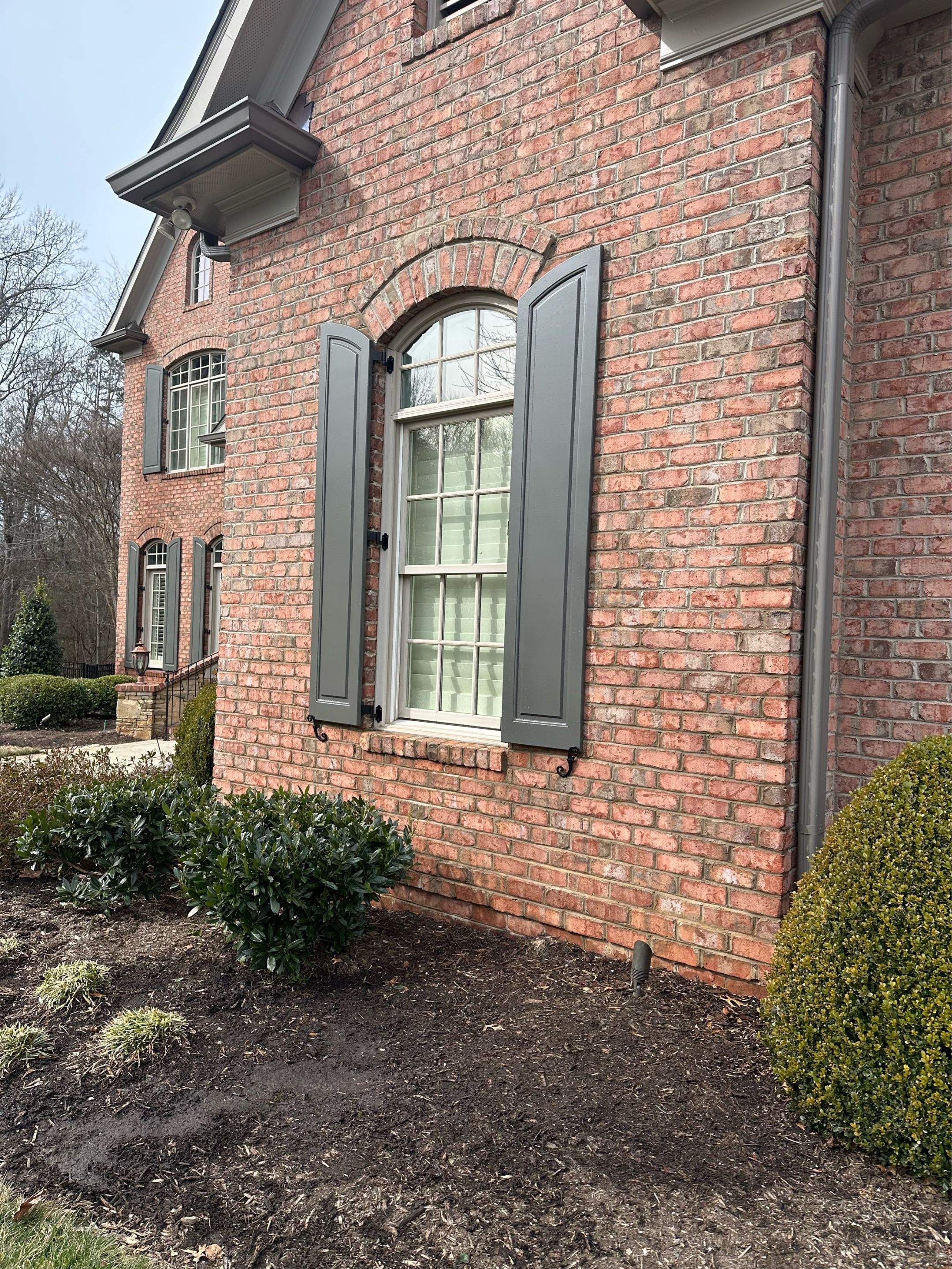 Exterior raised panel shutters by Southern Traditions Window Fashions