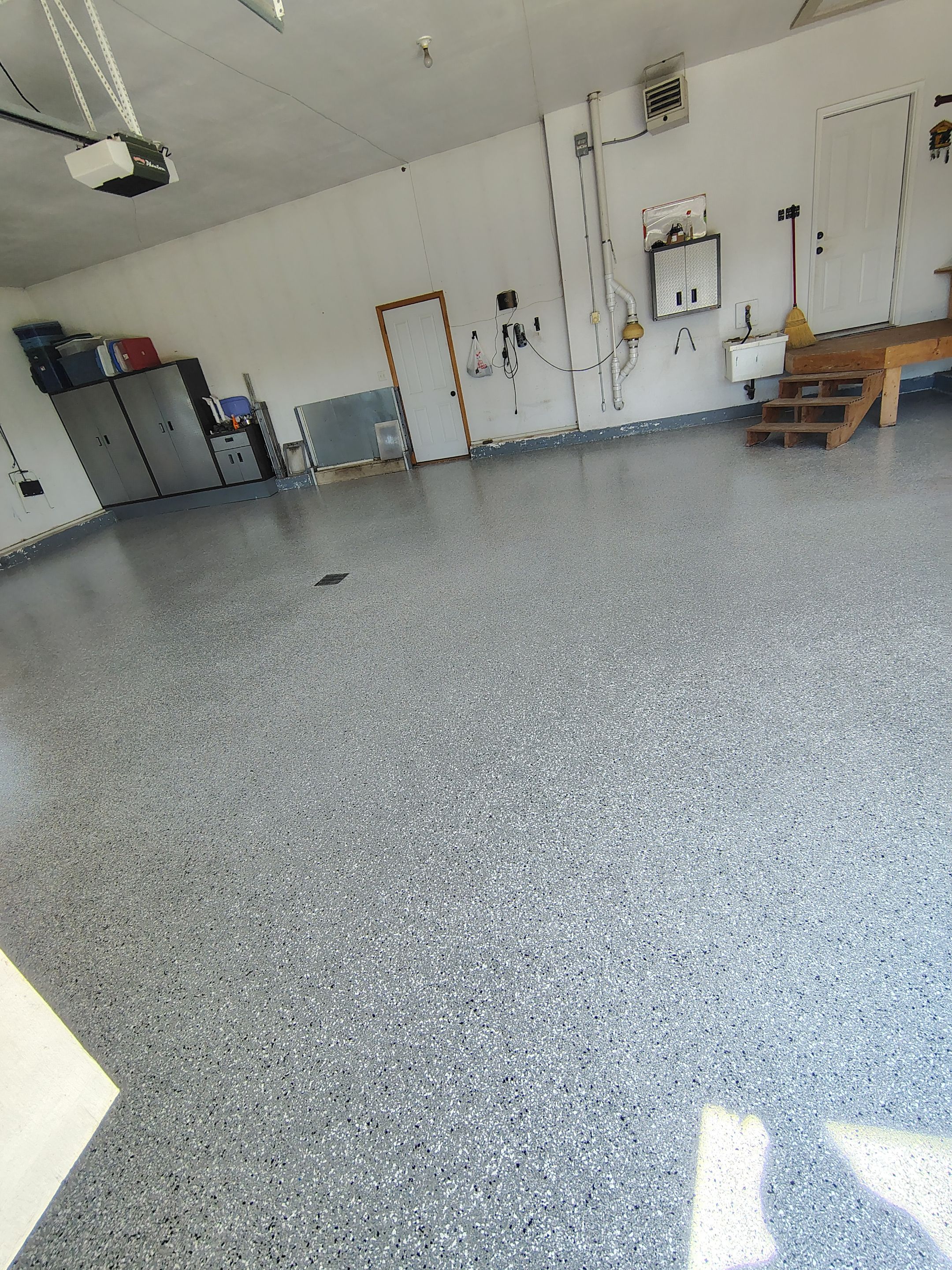 Feather Grey Garage Floor Coating Installation in Valley Springs by Select Painting, Coatings & Garage Cabinets