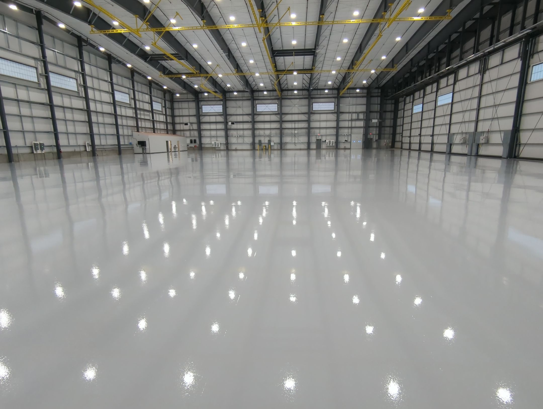 Airplane Hanger using Light Grey Commercial Penntek Epoxy by Croc Coatings, LLC