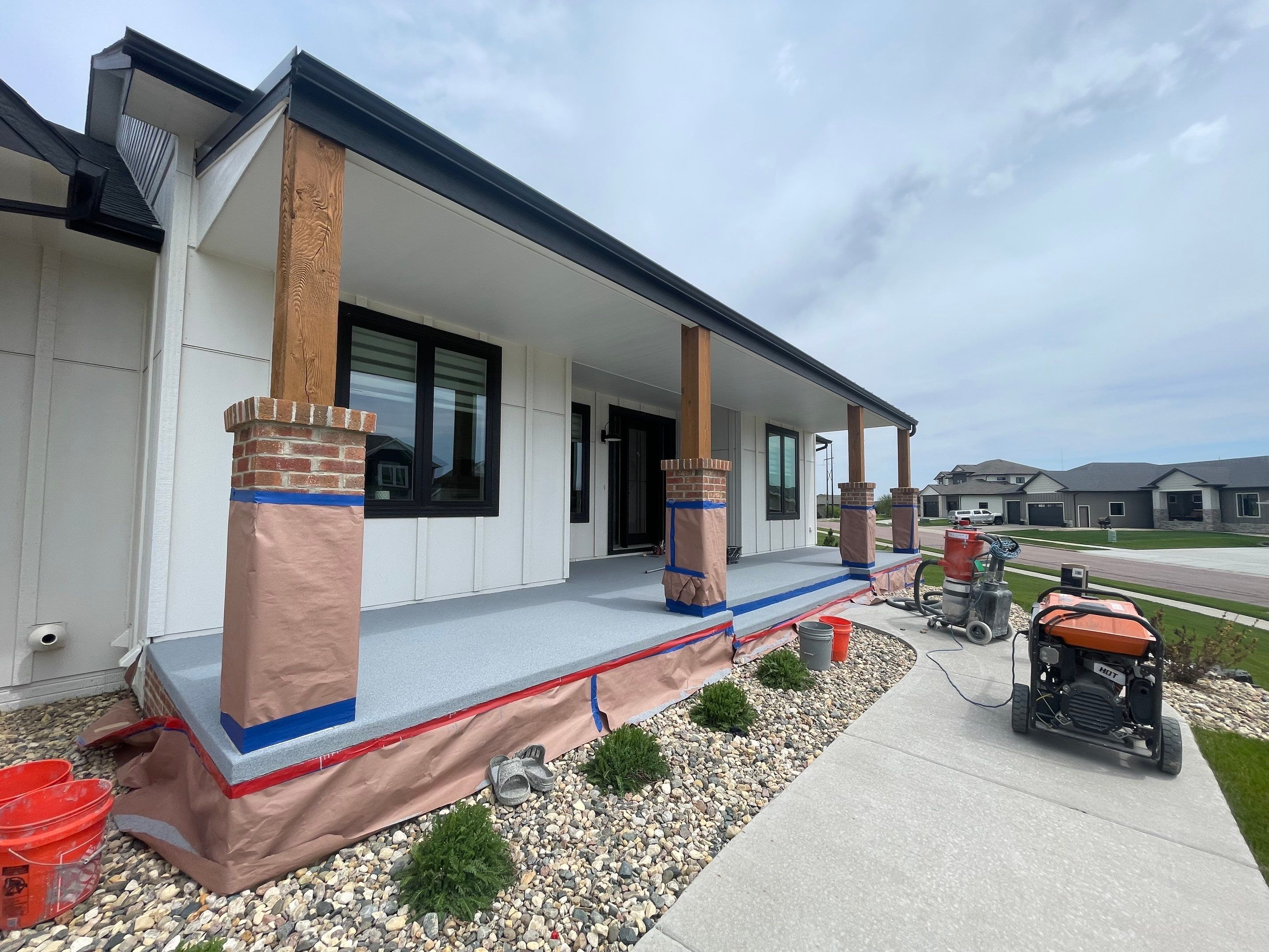 Grey Speckled Concrete Porch Coating for Sioux Falls Home by Select Painting, Coatings & Garage Cabinets