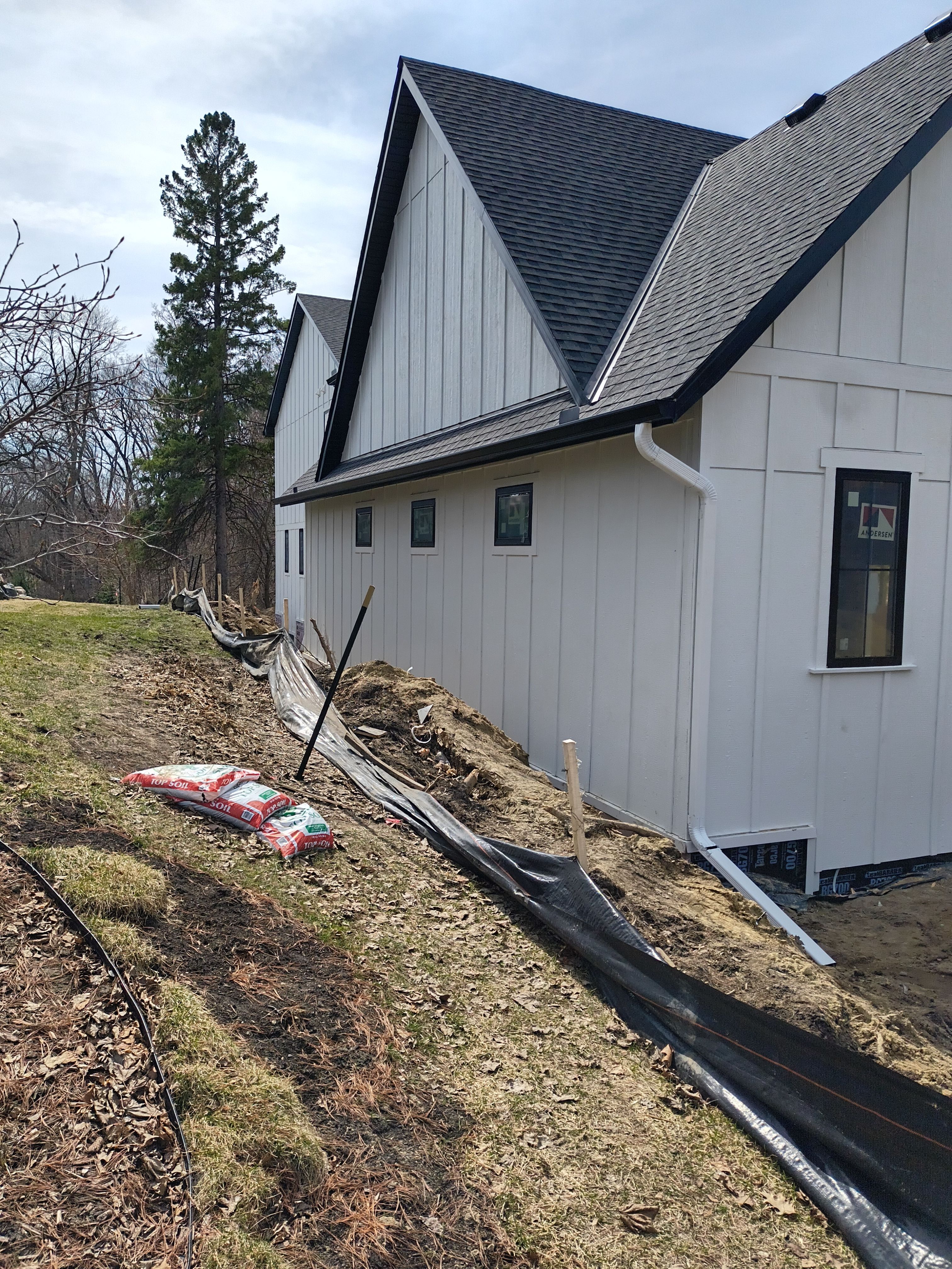 Black Seamless Gutter Installation for New Excelsior Home Build by Next Level Seamless Gutters / Exteriors Inc.