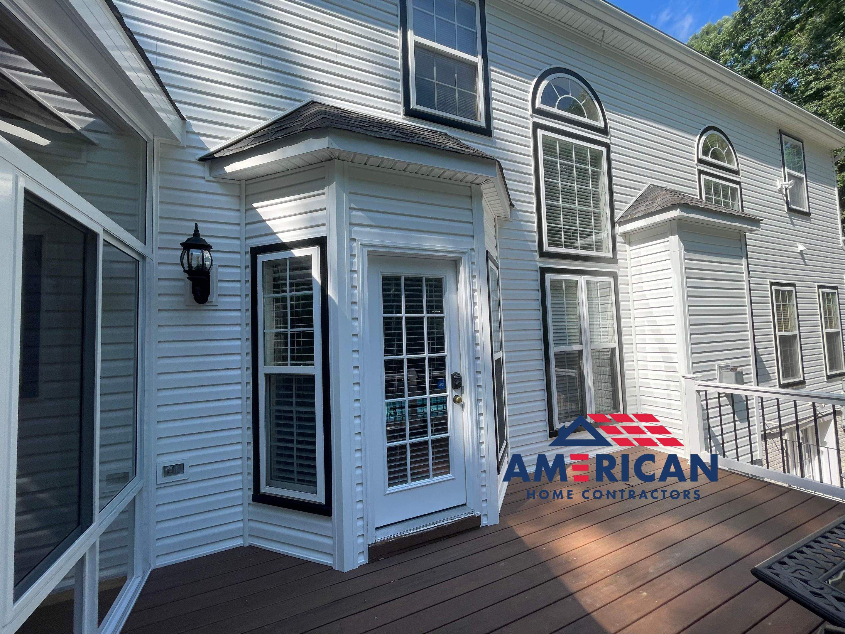 Vinyl Siding Replacement + Black Trim by American Home Contractors