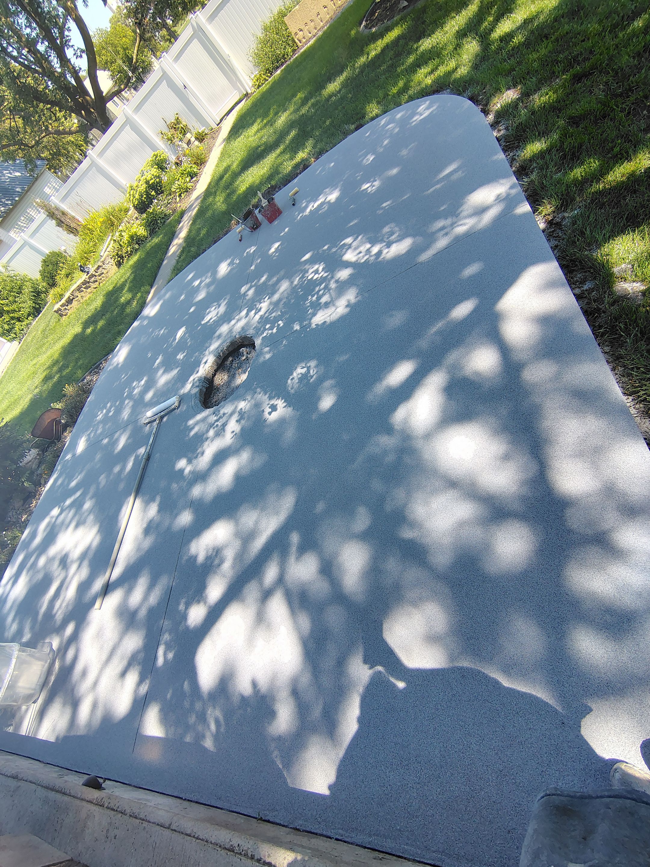 Custom Garage Floor Coating and Backyard Patio Refinishing in Tyndall by Select Painting, Coatings & Garage Cabinets