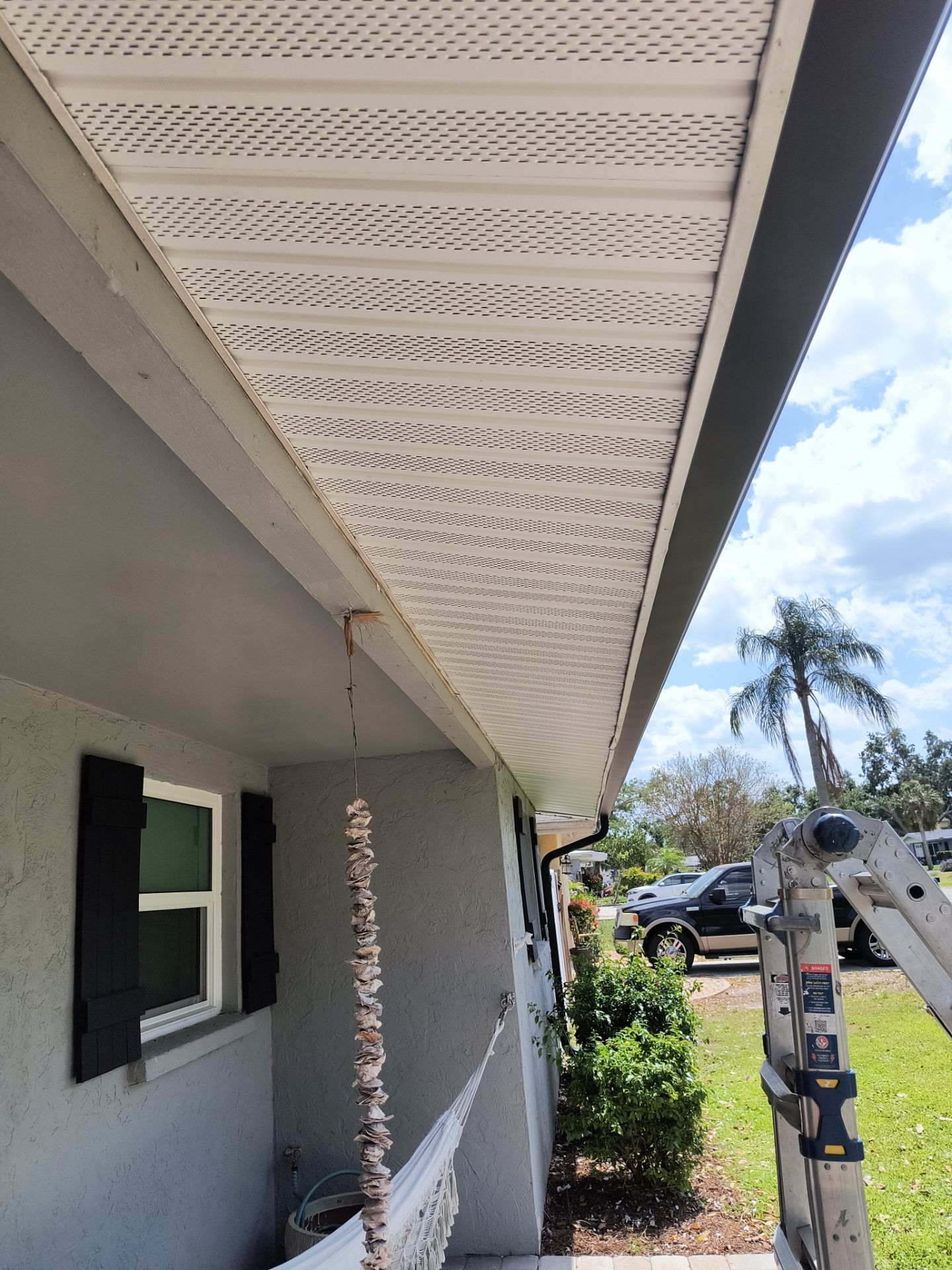 Black Seamless Gutters using 7 inch seamless gutters & New White Soffit in Sarasota FL by Gutter Professors
