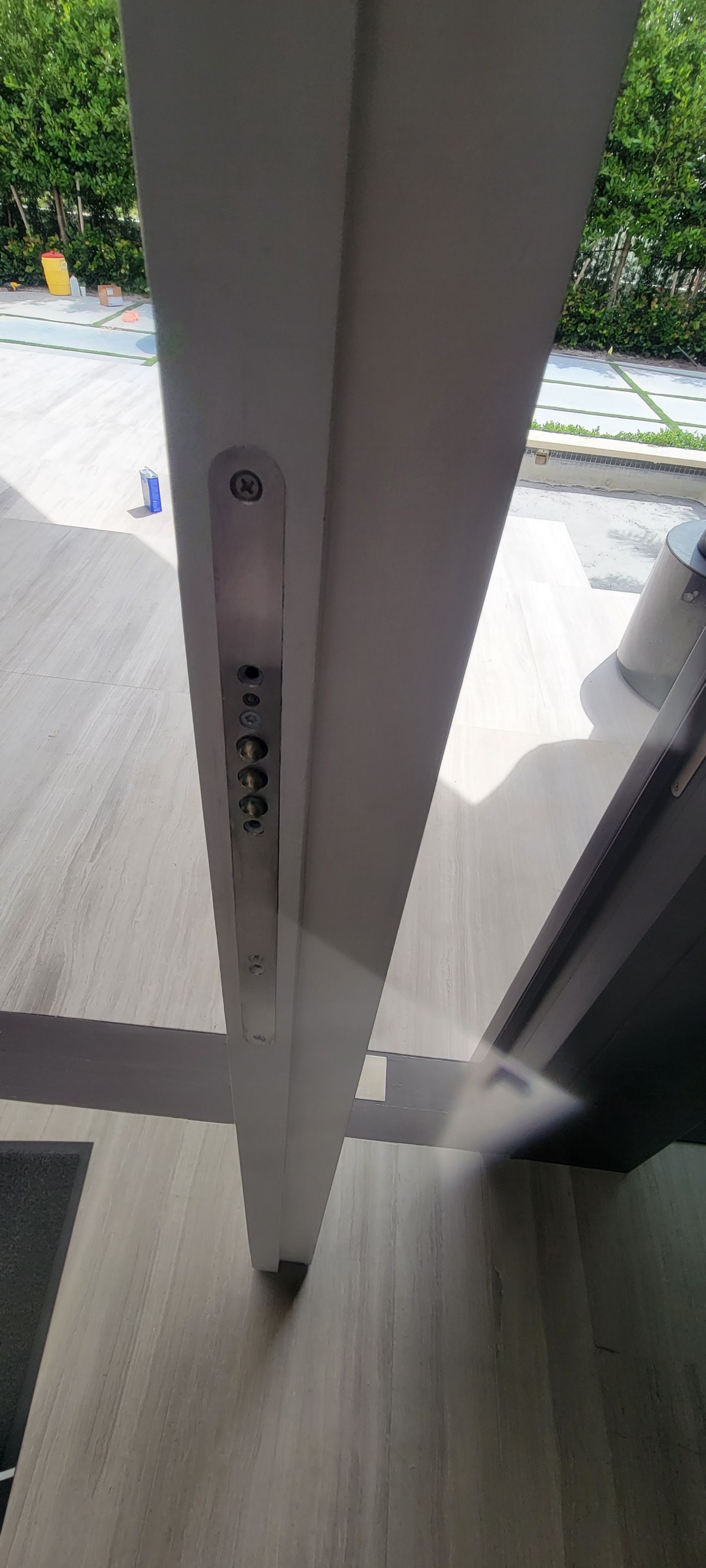Custom Material Pivot Door installation by Impact Precious Wood Inc.