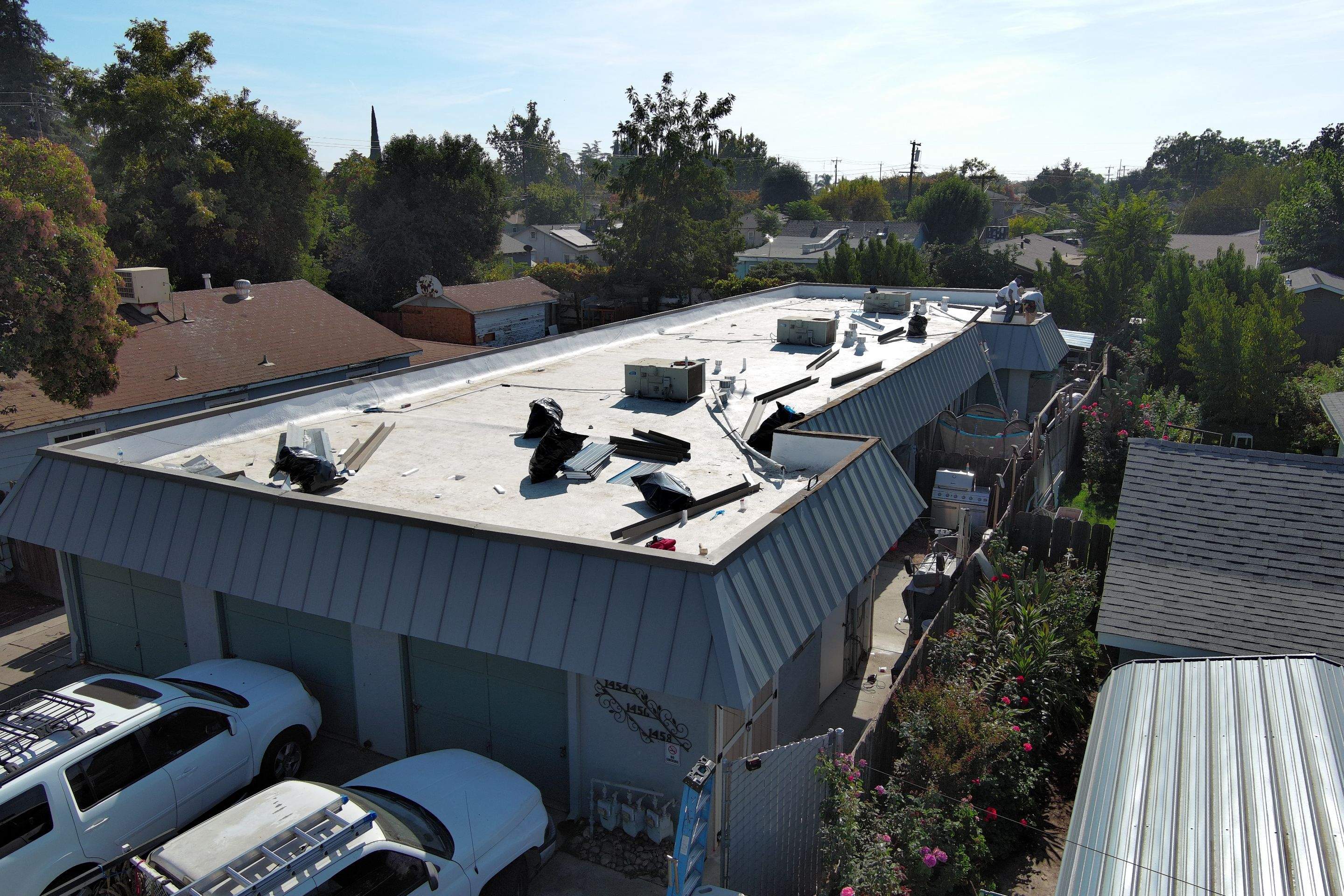 Foam Refurbish using Conklin Benchmark/PUMA XL coatings and spray foam; Also metal roofing around parapet wall by Straight Edge Roofing Inc