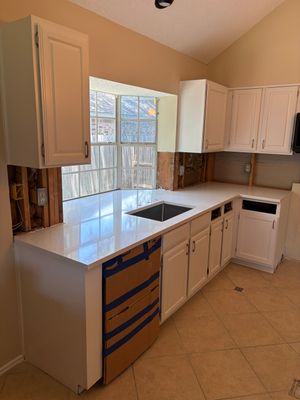 Removed the old stone bulky look for a new fresh upgrade with new Quartz countertops 
