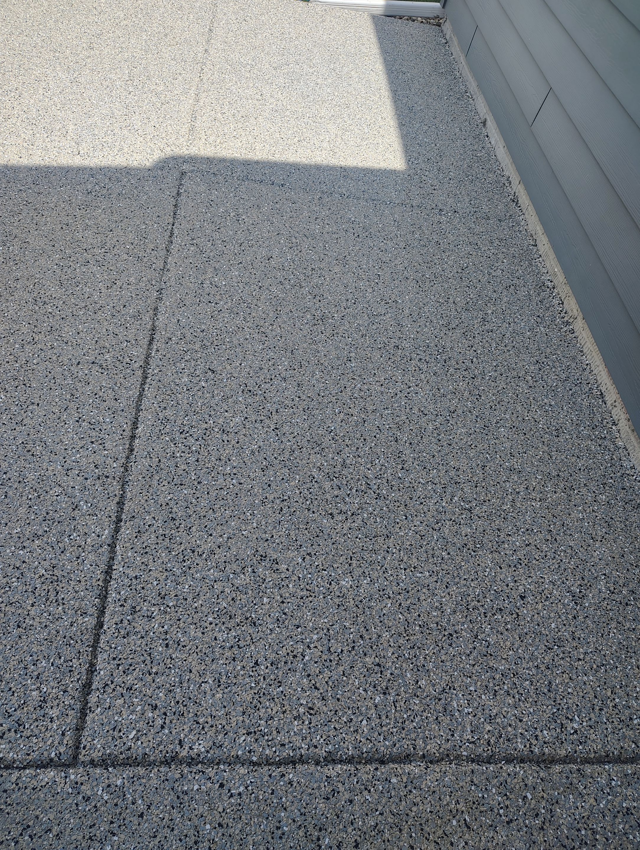 Speckled Concrete Patio Coating Installation in Sioux Falls by Select Painting, Coatings & Garage Cabinets