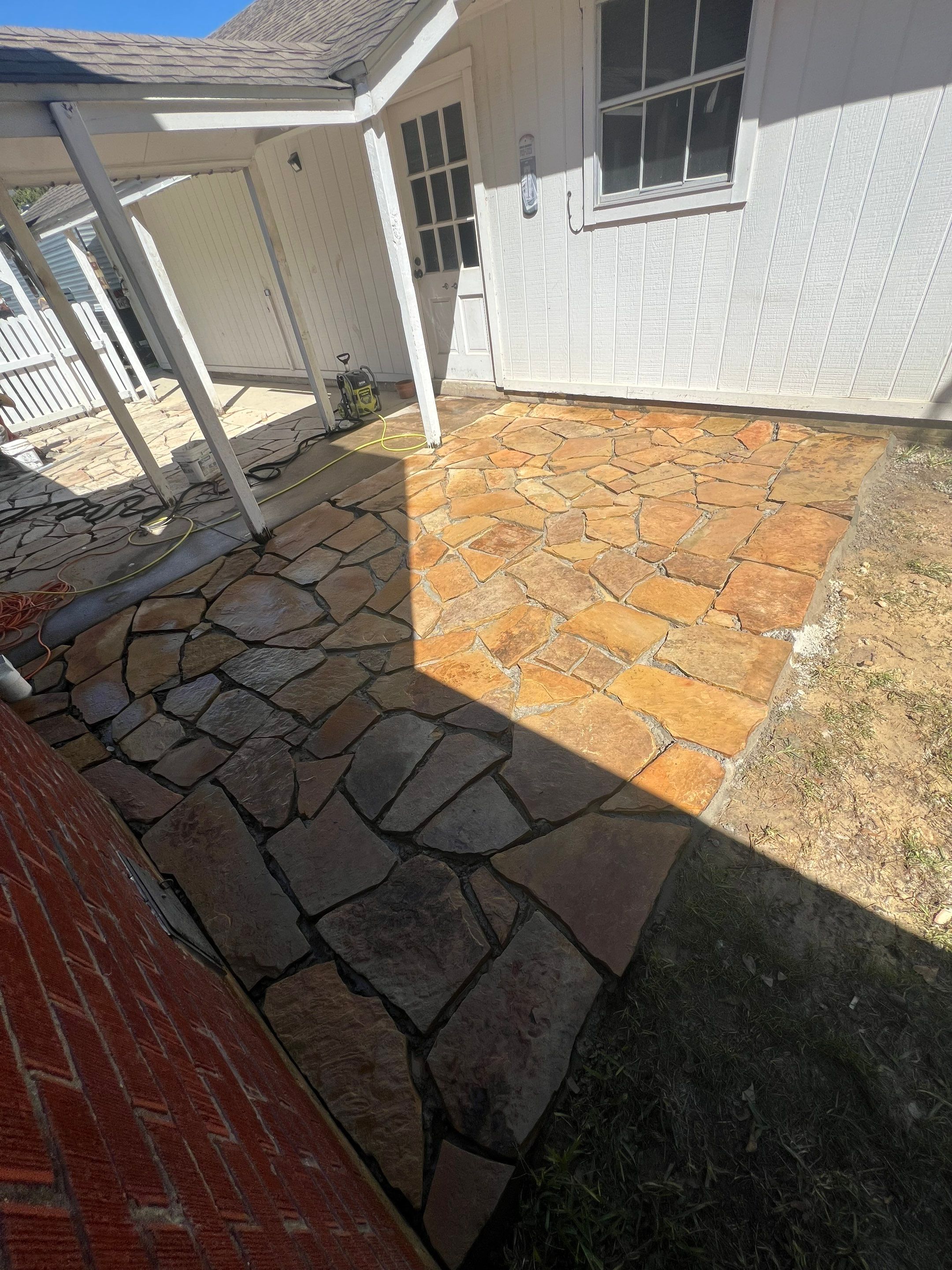 🌿 Rodney – Full Gutters, Drainage System, Flagstone Patio & Pergola  Alejandro and the Texas Urban Elements Team recently completed a multi-solution project for Rodney’s home, blending function with design.  ✅ Seamless Gutters We installed a complete 6” seamless gutter system around the home to properly redirect rainwater away from the foundation, protecting siding, paint, and landscaping while boosting curb appeal.  ✅ Drainage System A new PVC storm drainage system was integrated into the gutters and extended to carry roof runoff away from the house. This ensures water won’t pool near the foundation or the new patio area.  ✅ Flagstone Patio Ground We prepped, leveled, and installed a custom flagstone patio for Rodney—delivering both beauty and durability, creating a natural, timeless look that ties perfectly into the yard.  ✅ Pergola Addition To conclude, our framing team constructed a small pergola extension, providing Rodney’s patio with a shaded retreat for family and friends to enjoy.  ✨ Result: A fully protected and enhanced outdoor living space where drainage, stonework, and structure all work together for long-lasting performance and comfort.  📢 At Texas Urban Elements, we specialize in building solutions that protect homes while creating beautiful outdoor environments. by Texas Urban Elements