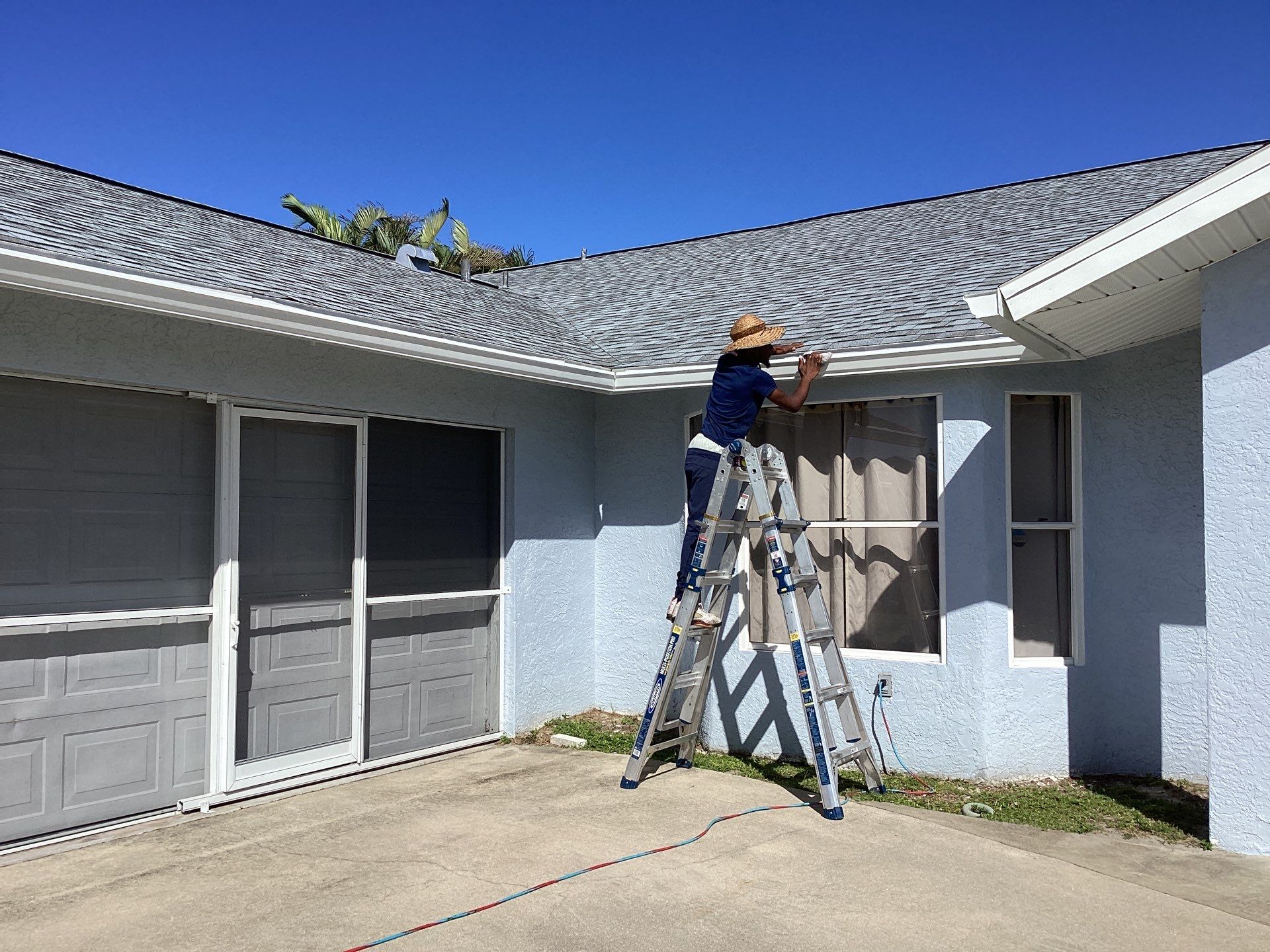 New White Seamless Gutters with Downspouts and Splash Guards in Cape Coral FL by Gutter Professors