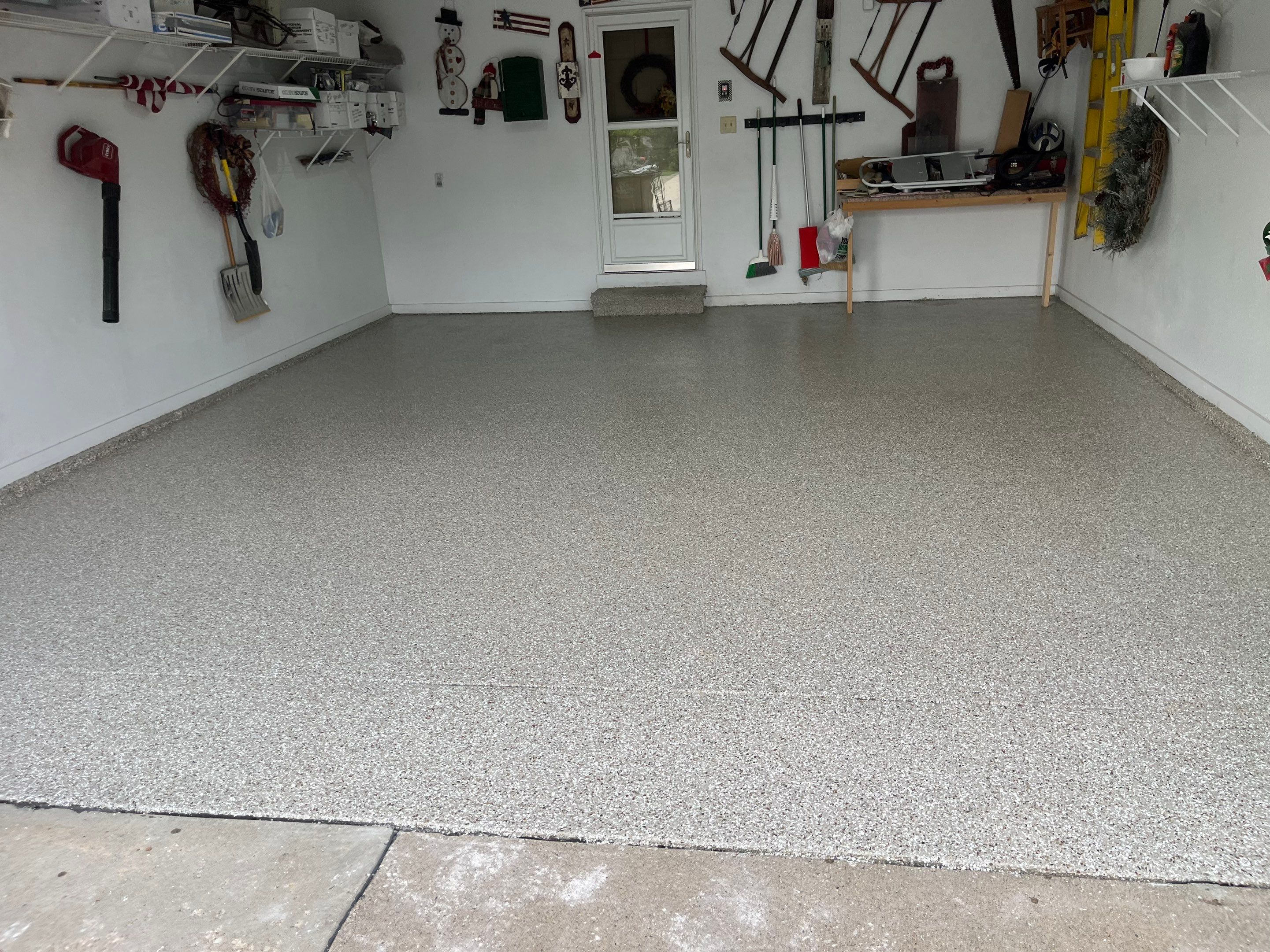 West Des Moines Garage and Patio Floor Coating using Pebble Beach Flakes by Revival Concrete Coatings, LLC