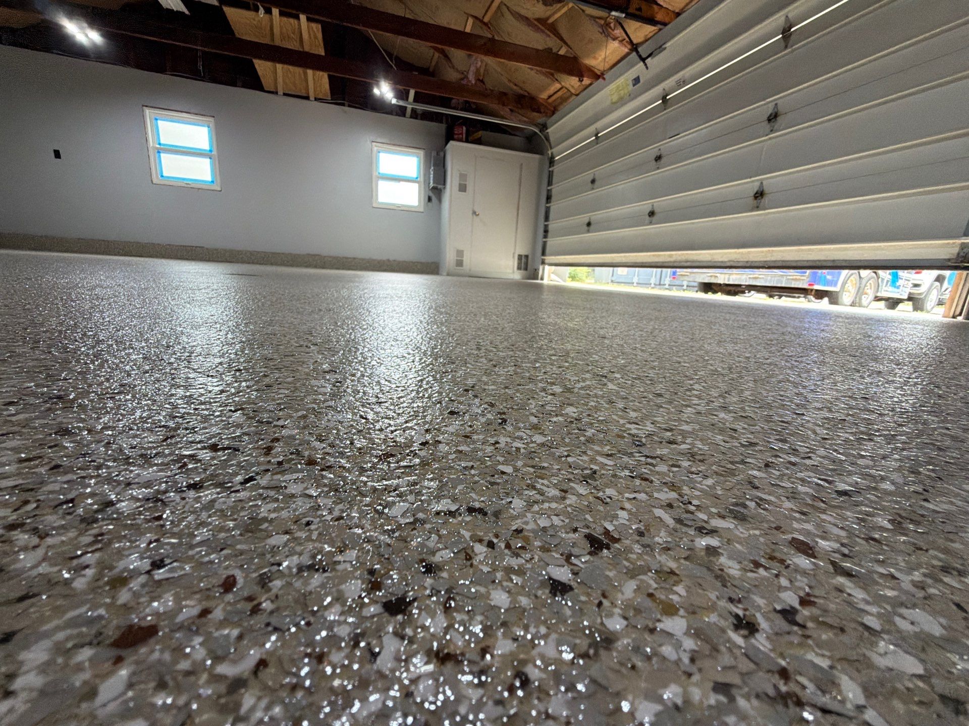 Garage Epoxy Flake Floor Installation and Exterior Siding Repairs in Muskegon by Gordon Painting