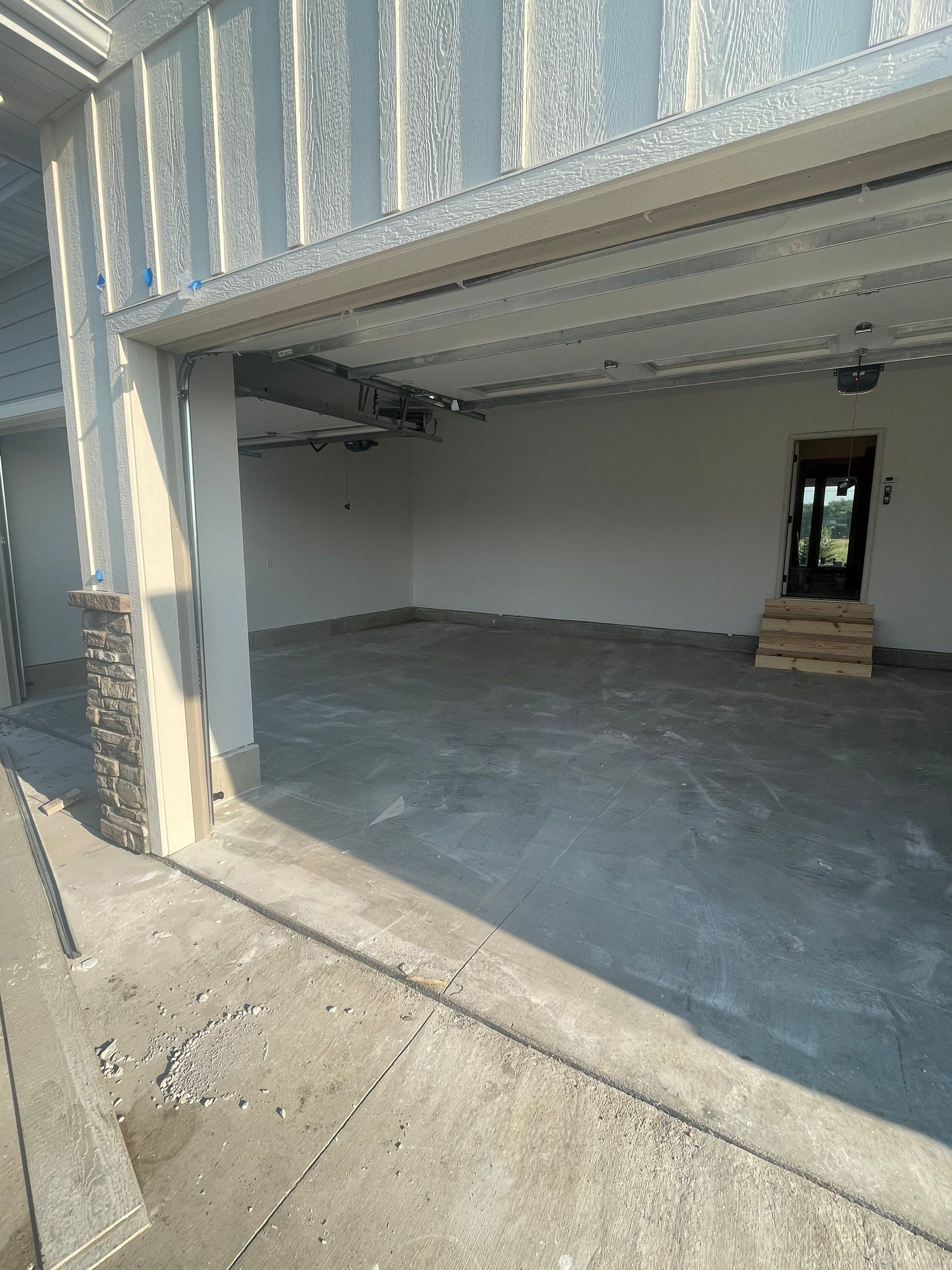 Grey Speckled Garage Floor Coating in Sioux Falls by Select Painting, Coatings & Garage Cabinets