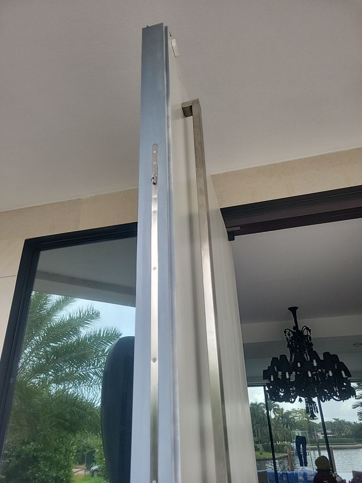 Custom Material Pivot Door installation by Impact Precious Wood Inc.