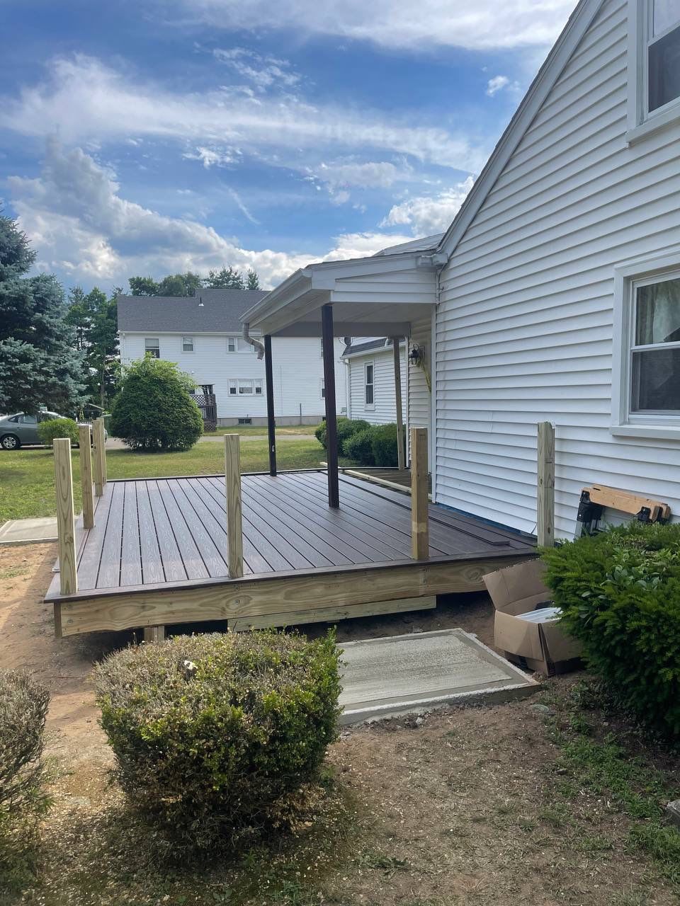 New deck using Trex Tropical Lava rock, Transcend railings in Vintage Lantern with matching fascia. by DiGiorgi Roofing and Siding Inc
