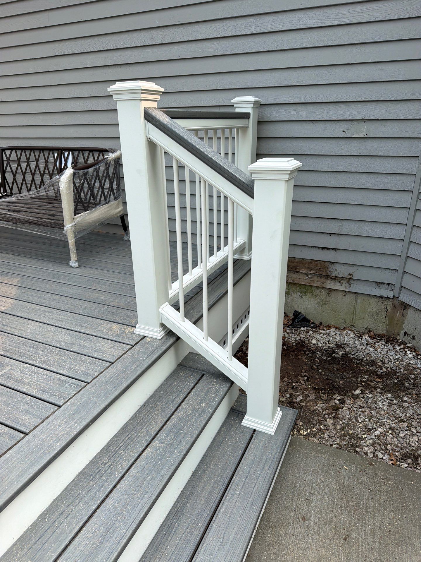 Replacement deck using Trex Tropical Island mist decking and matching cocktail railing. Enclosed with Lattice by DiGiorgi Roofing and Siding Inc