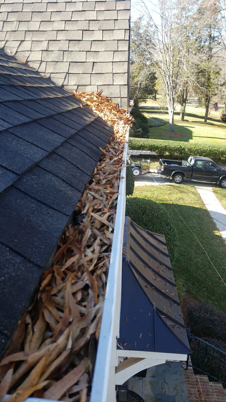 Sara Gutter cleanout using water by Power Wash Masters LLC