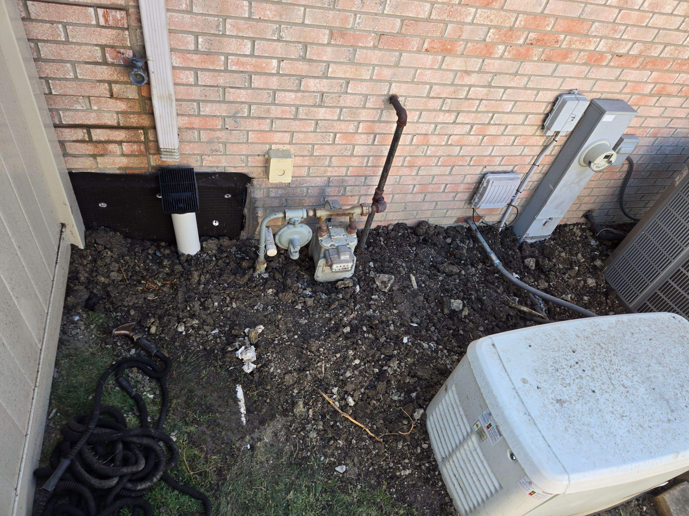 Burial of Sump Pump and Down Spout Discharges and Partial Waterproofing of Wall by Allied Water Services