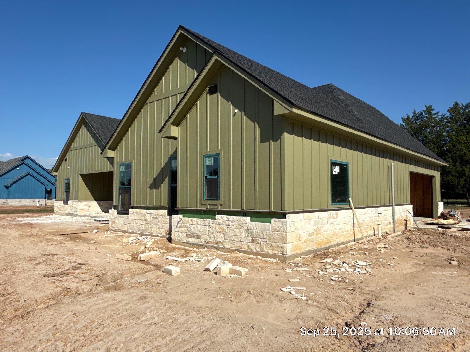 Cleveland Ranch Charm: Natural Stone Wainscot with Green Accent Siding. by Apex Conventional Stucco Llc