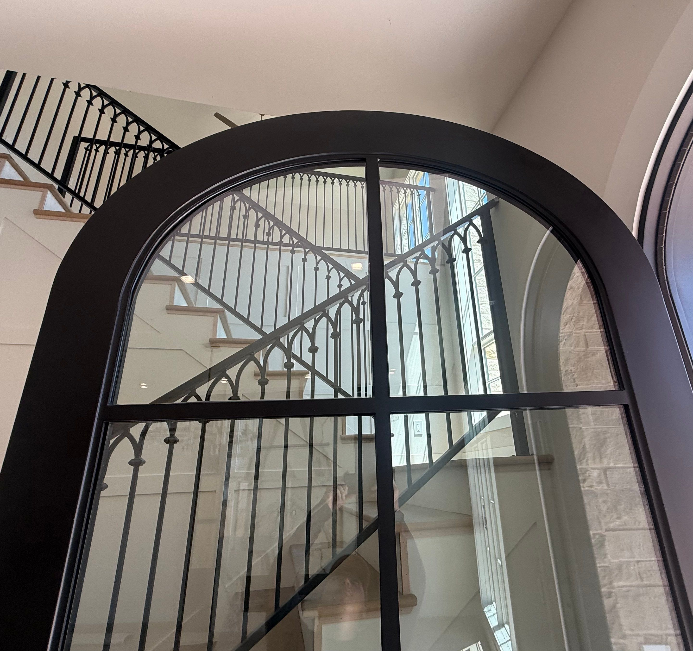 Custom Black Metal Arched Entry Door Installation in Southlake by Solara Custom Living