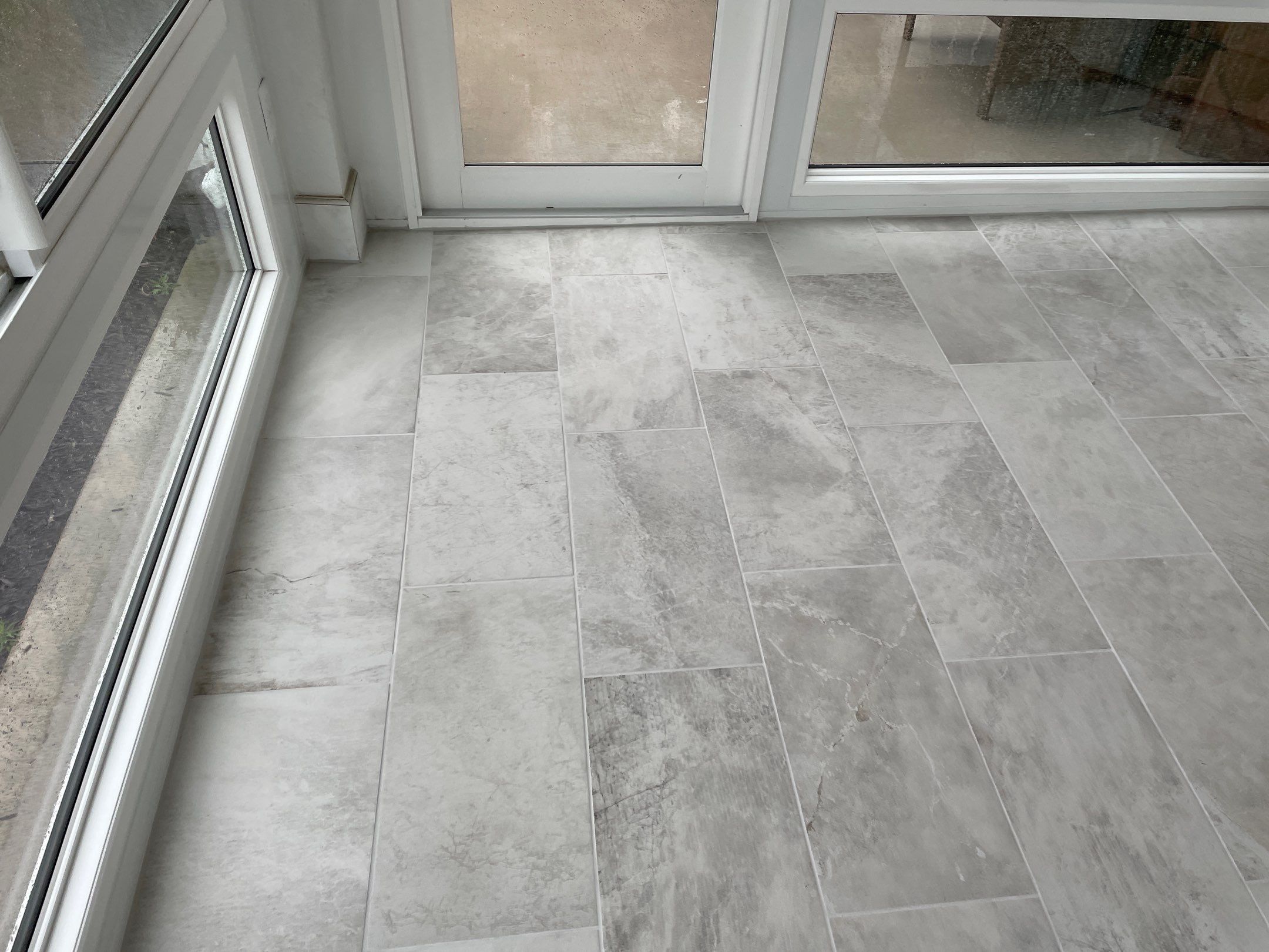 Amazing Tile Transformation After Enclosed Windows Added to Sunroom by Footprints Floors of Coastal Carolina