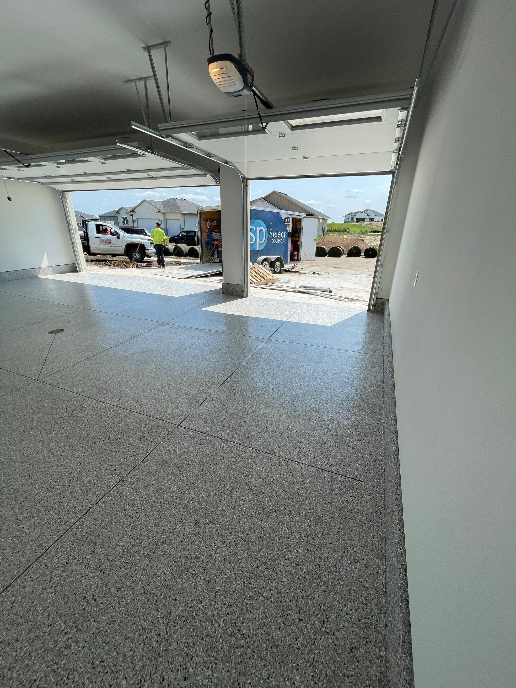 Grey Speckled Garage Floor Coating in Sioux Falls by Select Painting, Coatings & Garage Cabinets