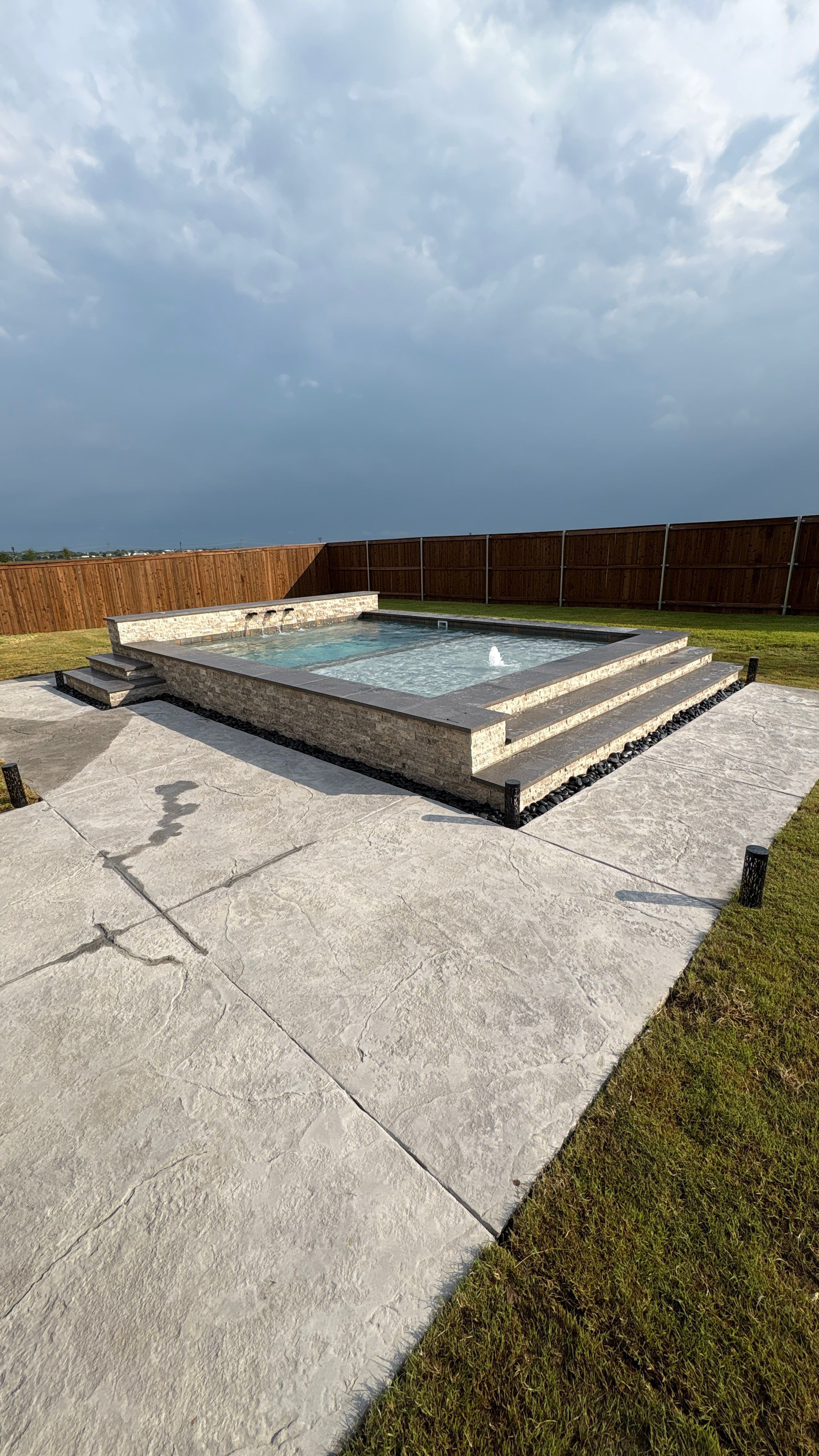 Modern Spool with Tanning Ledge and In-Water Loungers by Pinnacle Pools and Spas - DFW