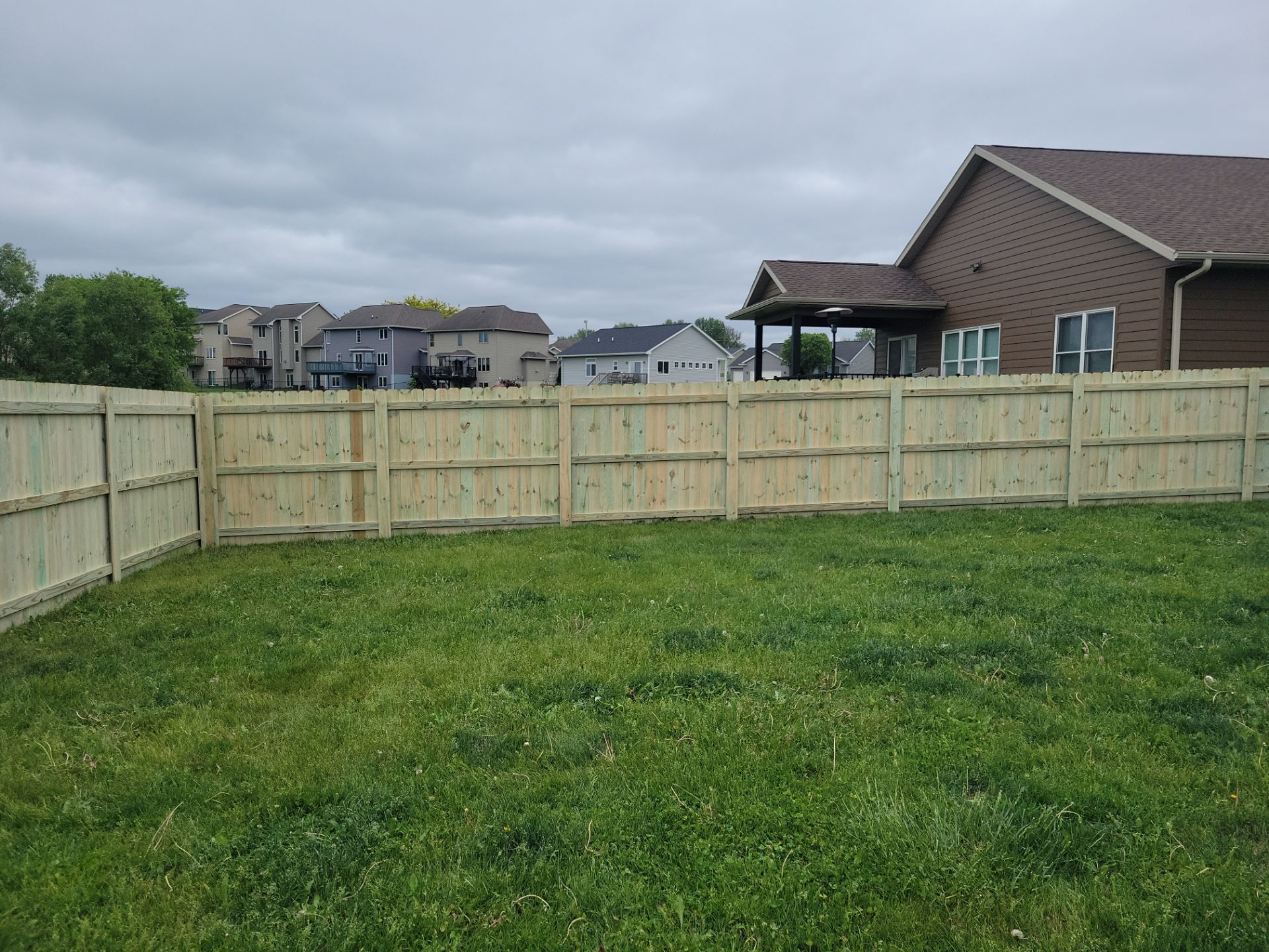 Pressure-Treated Wood Privacy Fence Installation in Waterloo by Perfect Picket Fence and Stain