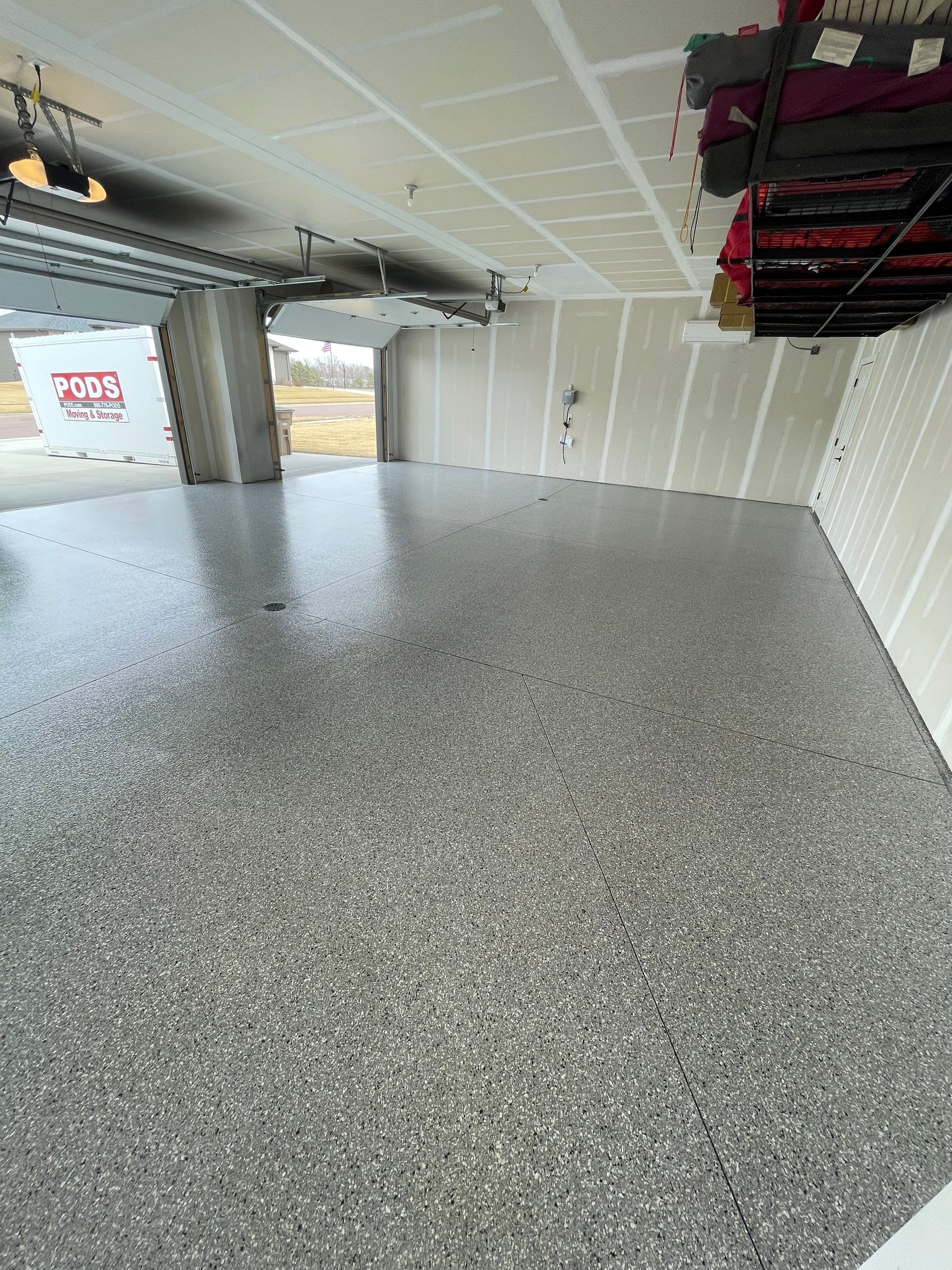 Grey Speckled Epoxy Floor Coating for Sioux Falls Garage by Select Painting, Coatings & Garage Cabinets