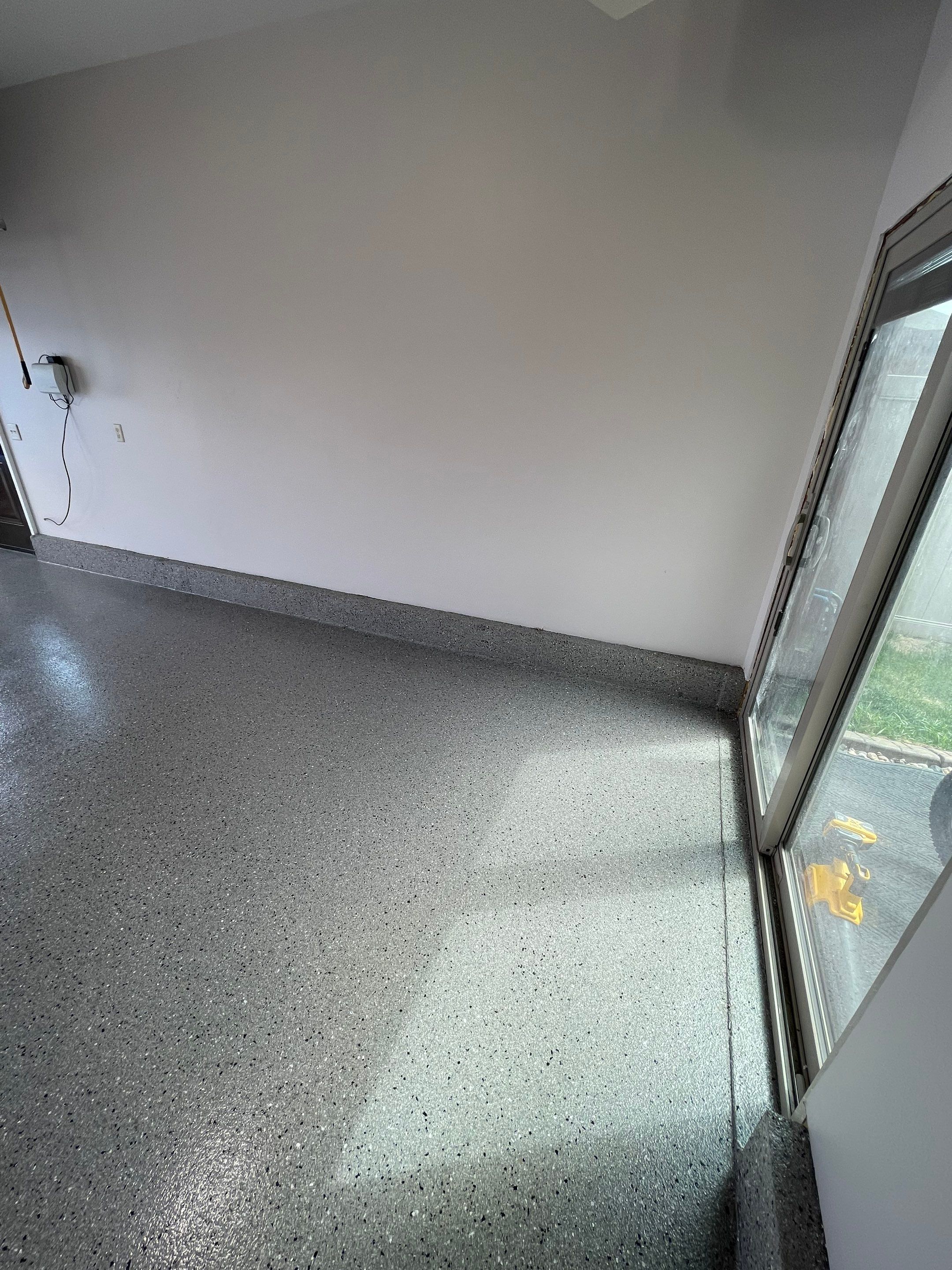 Residential Garage Floor Coating with Grey Speckled Epoxy Finish by Select Painting, Coatings & Garage Cabinets