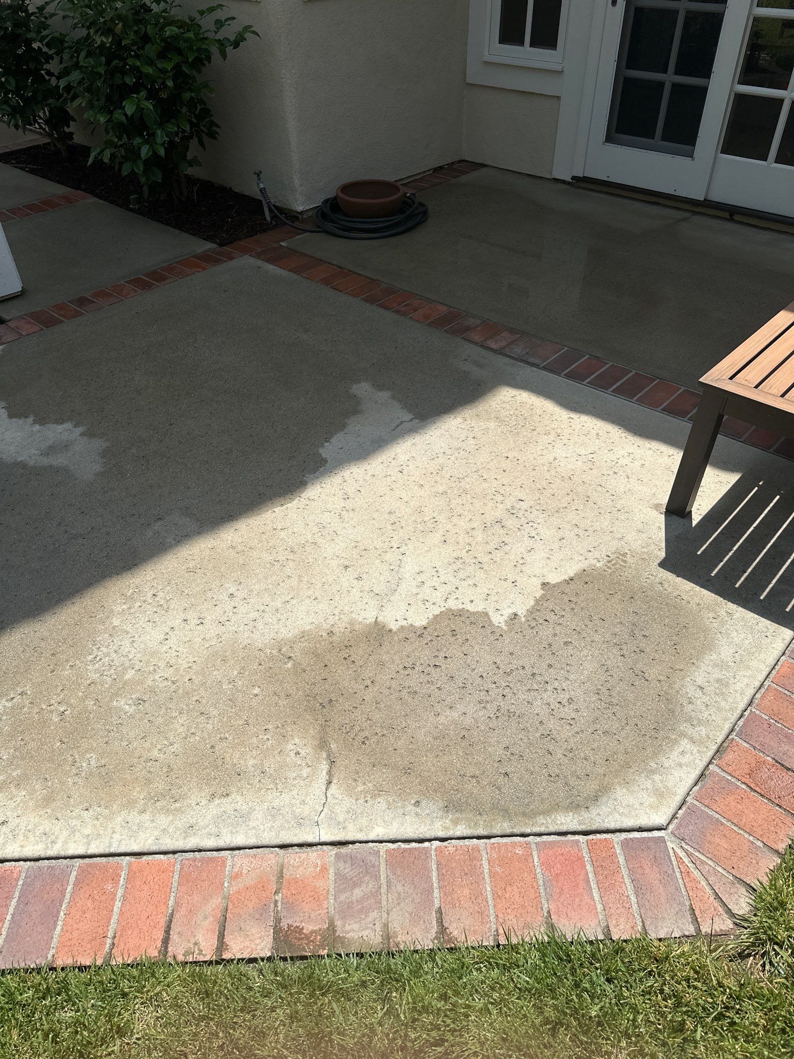 Surface cleaning pressure washing in Orange County on patio, walkways, and driveway by Property Cleaning Experts, LLC