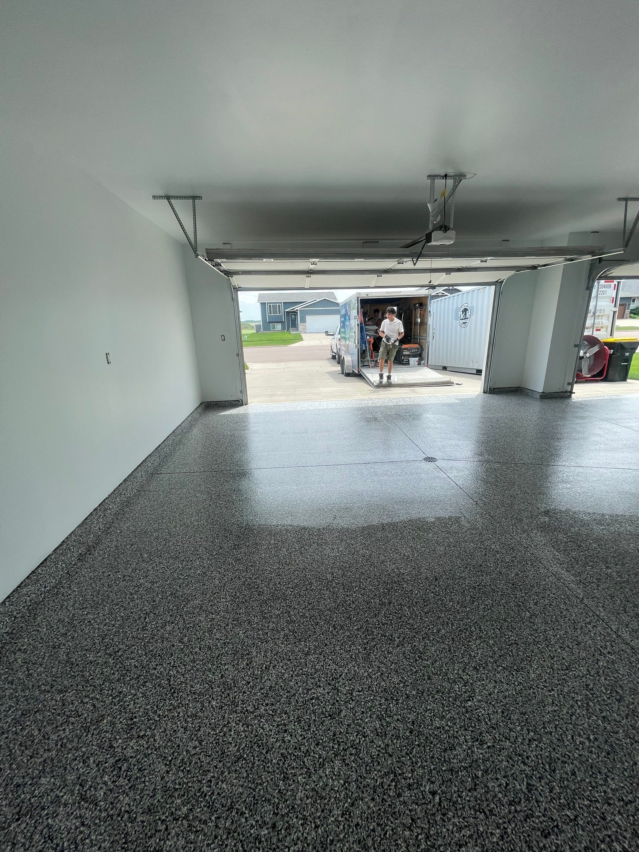Grey Flake Epoxy Garage Floor Coating in Sioux Falls by Select Painting, Coatings & Garage Cabinets