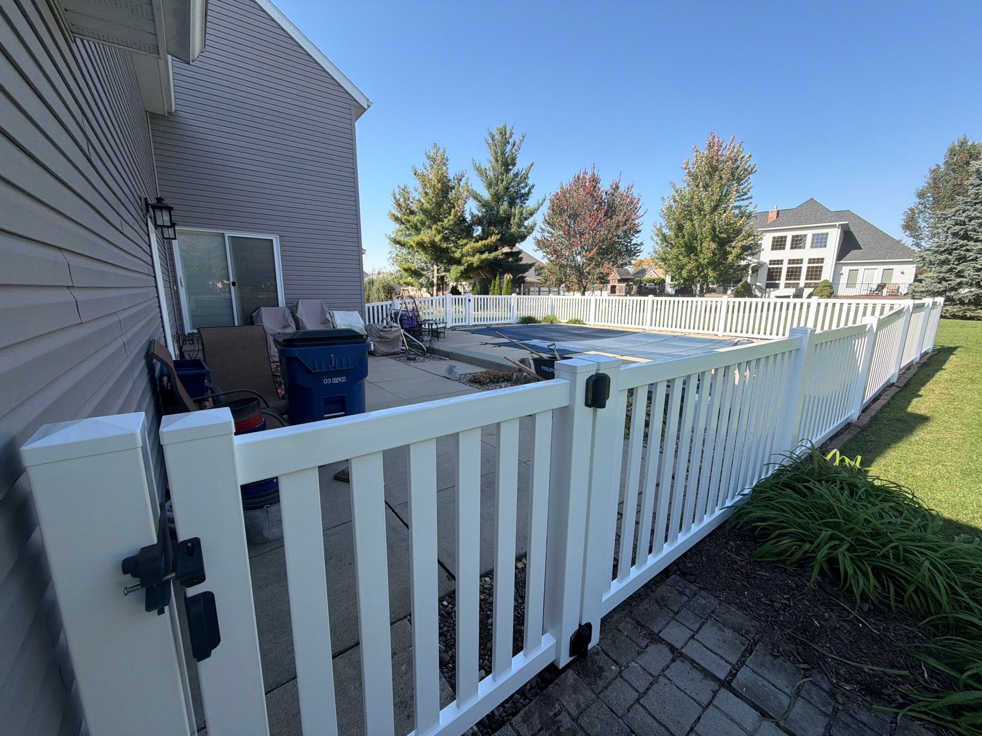 White Vinyl Picket Pool Fence Installation in Waterloo, Iowa by Perfect Picket Fence and Stain