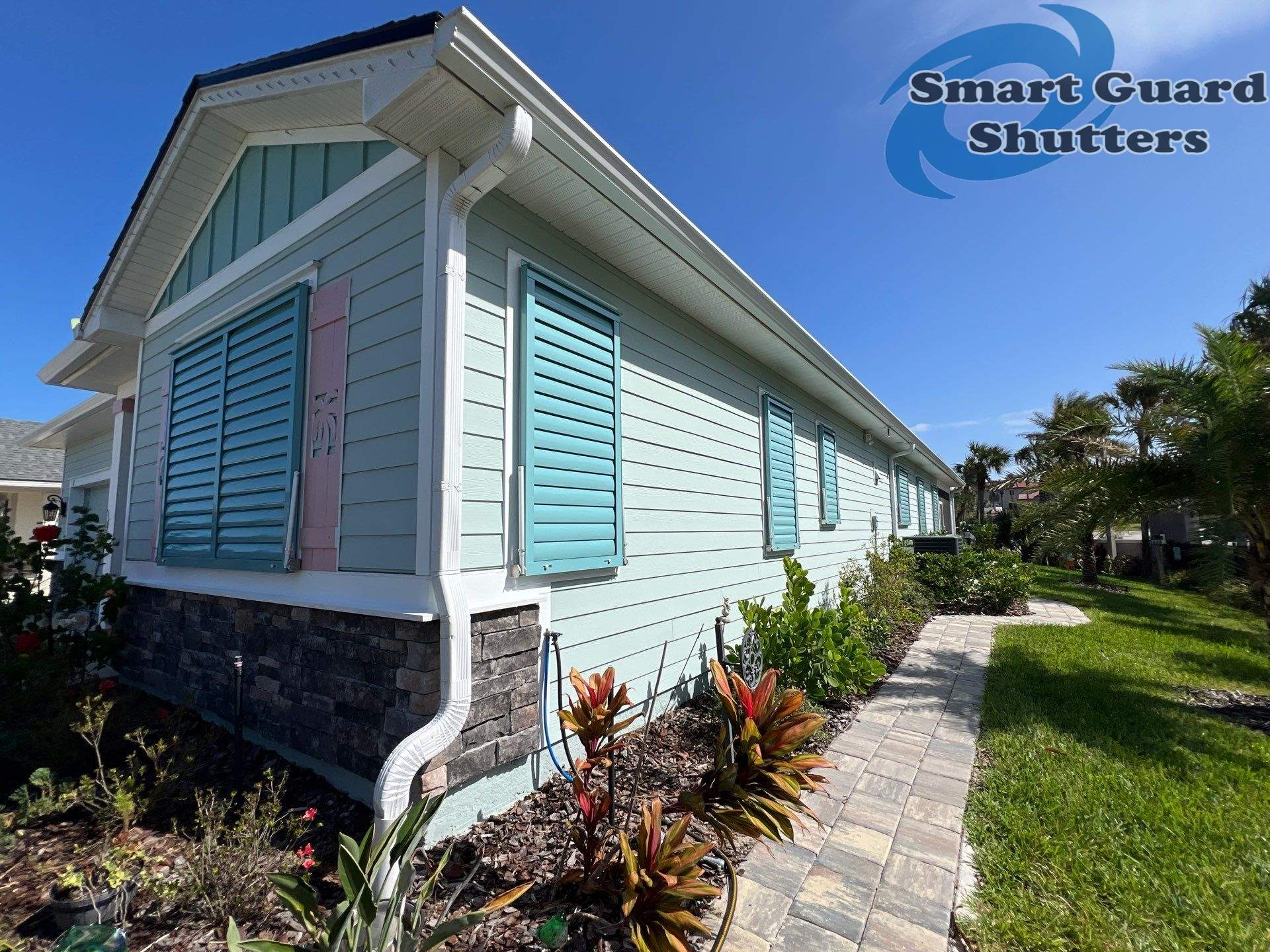 Impact Bahama Shutters in Pastel Turquoise by Smart Guard Shutters