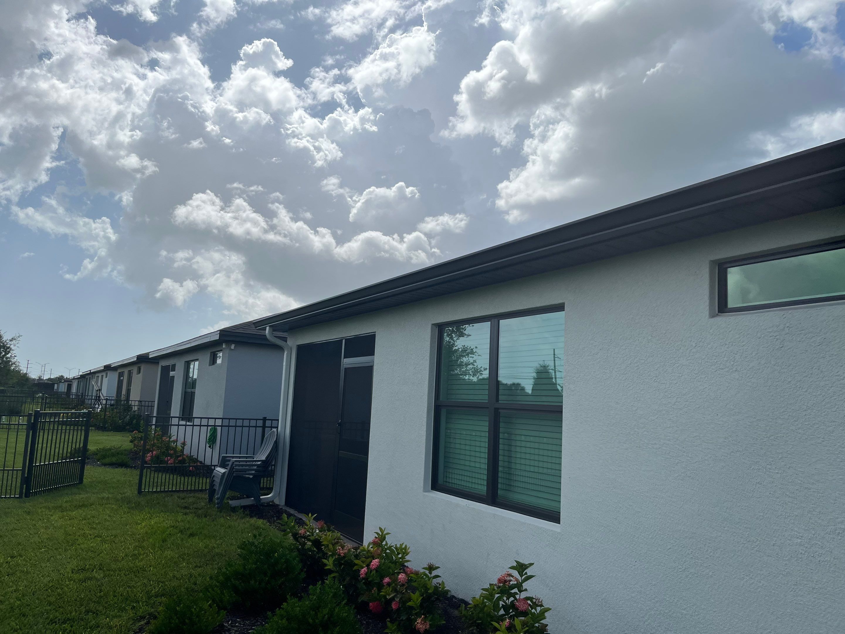 Dark Bronze Gutters and White Downspouts in Sarasota FL by Gutter Professors