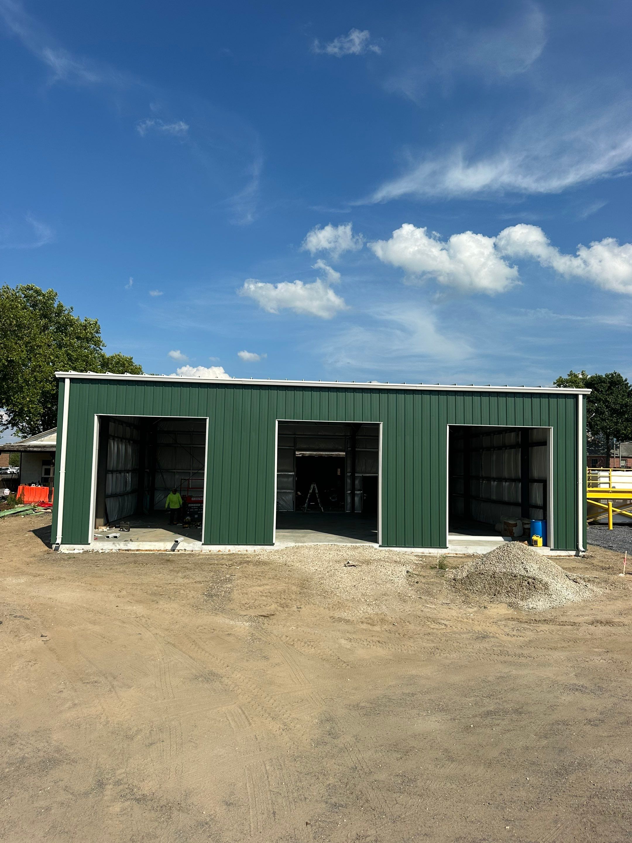 Dark Green Metal Siding by Reimagine Roofing
