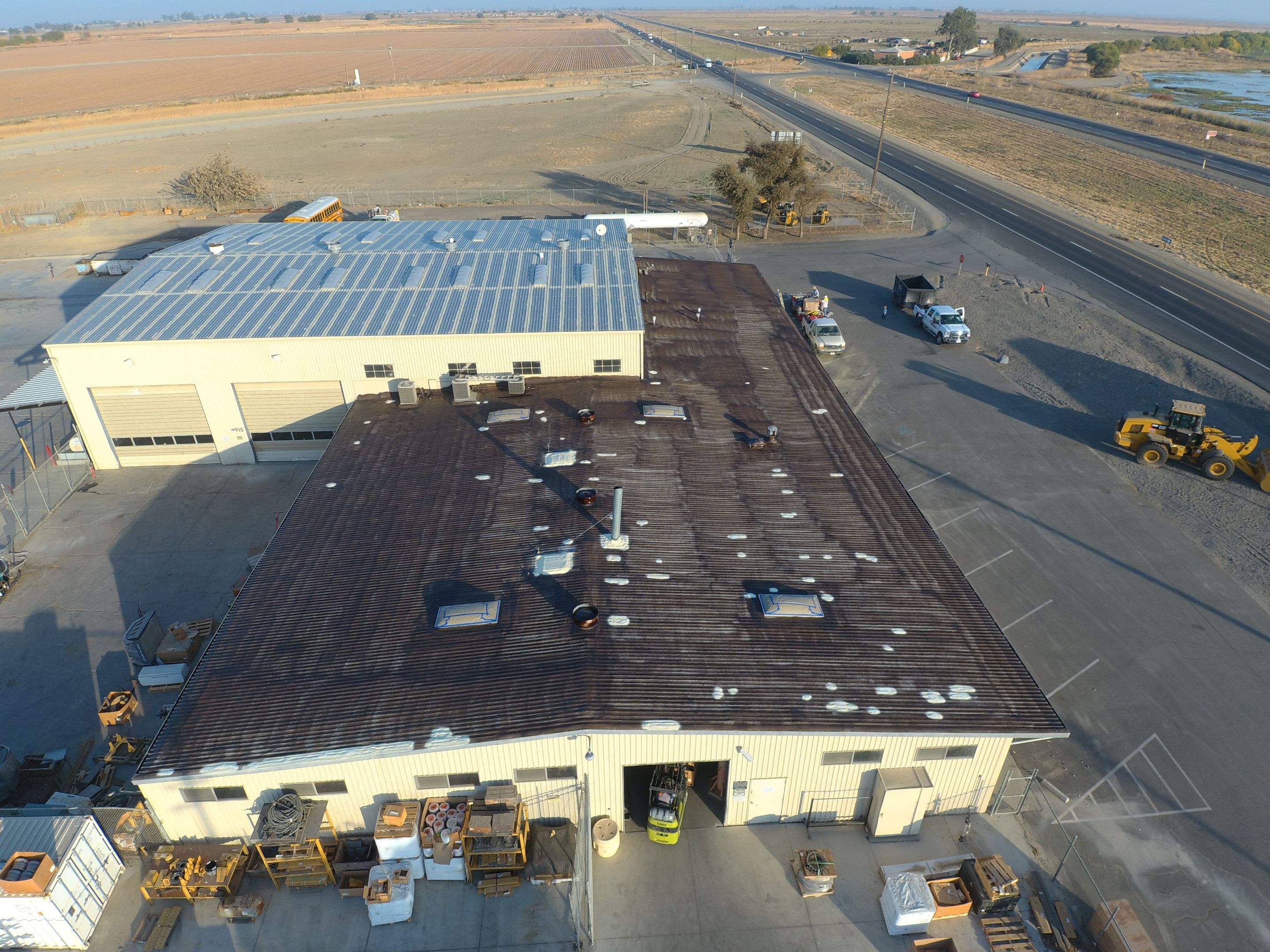 Metal roof restoration on commercial roof using Conklin Benchmark/ PUMA XL acrylic coatings over metal and foam by Straight Edge Roofing Inc