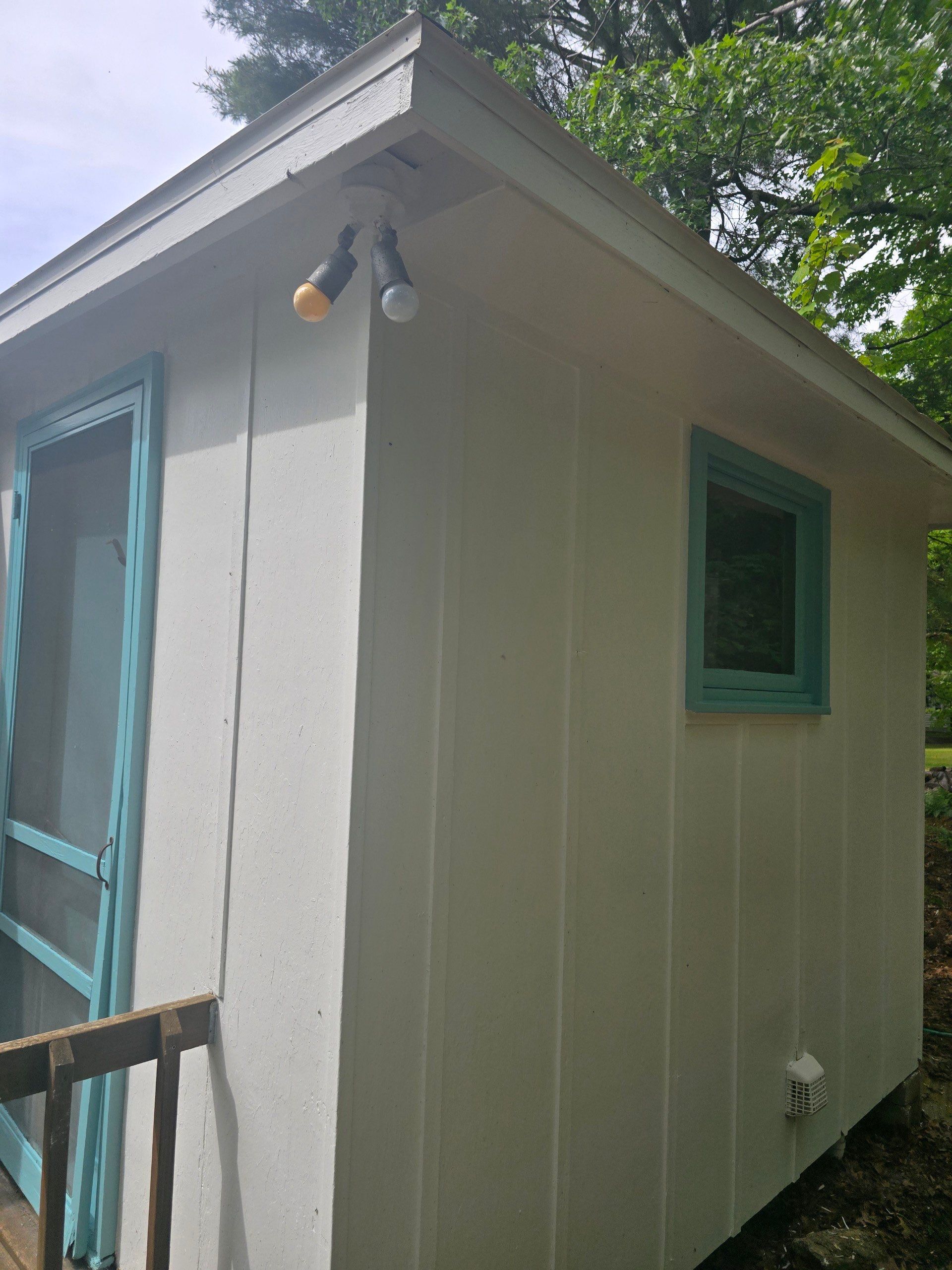 Lakeside Cottage Exterior Painting and Teal Trim Restoration in Mears by Gordon Painting